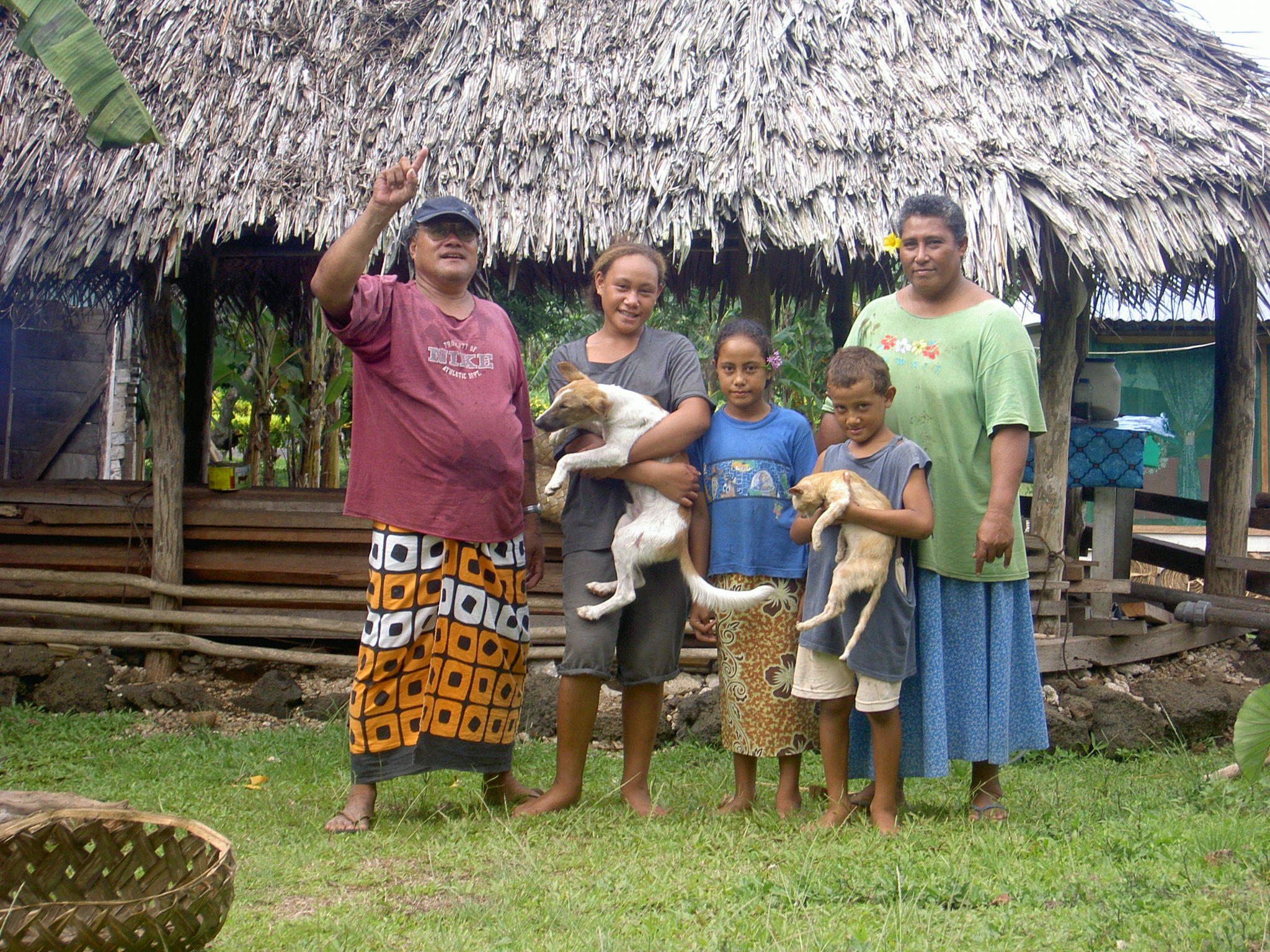 Familie vor ihrem Haus auf Samoa