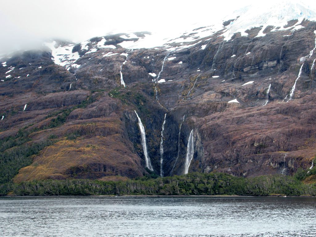 Meltwater pours over spectacular waterfalls in Parque Nacional Alberto de Agostini in the southern section of Isla Grande de Tierra del Fuego, Chile.