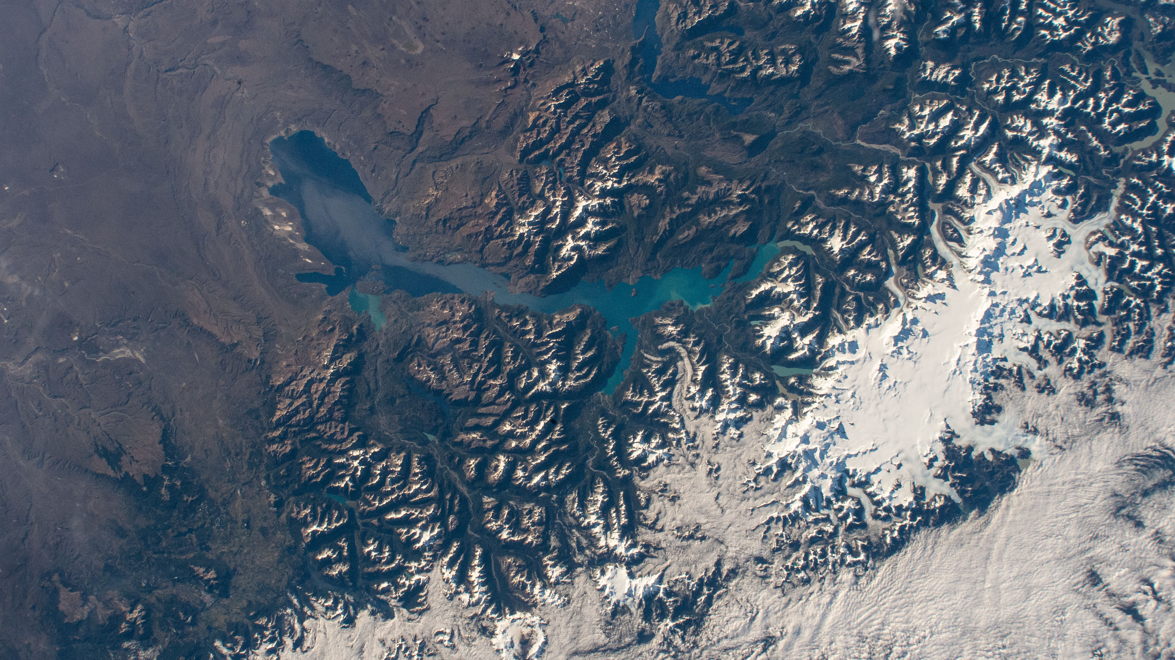 iss064e029029 (Feb. 2, 2021) --- Laguna San Rafael National Park comprises General Carrera Lake and the snow-capped peaks of the Andes in this picture from the International Space Station as it orbited 270 miles above southern Chile in South America. Glaciers, Northern Patagonian Ice Field