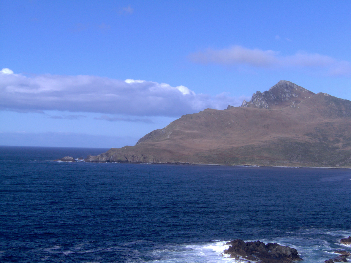 Cape Horn seen from the Chilean Station and Memorial location on 05/12/2006 at 08:00 AM. The small lighthouse can be seen as a white spot close to the seaside