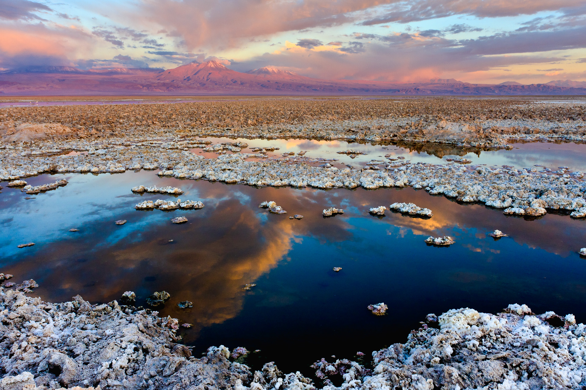 The Atacama Dry lake, in Chile. At the horizon, the Tumisa, Lejía and Miñiques volcanoes.