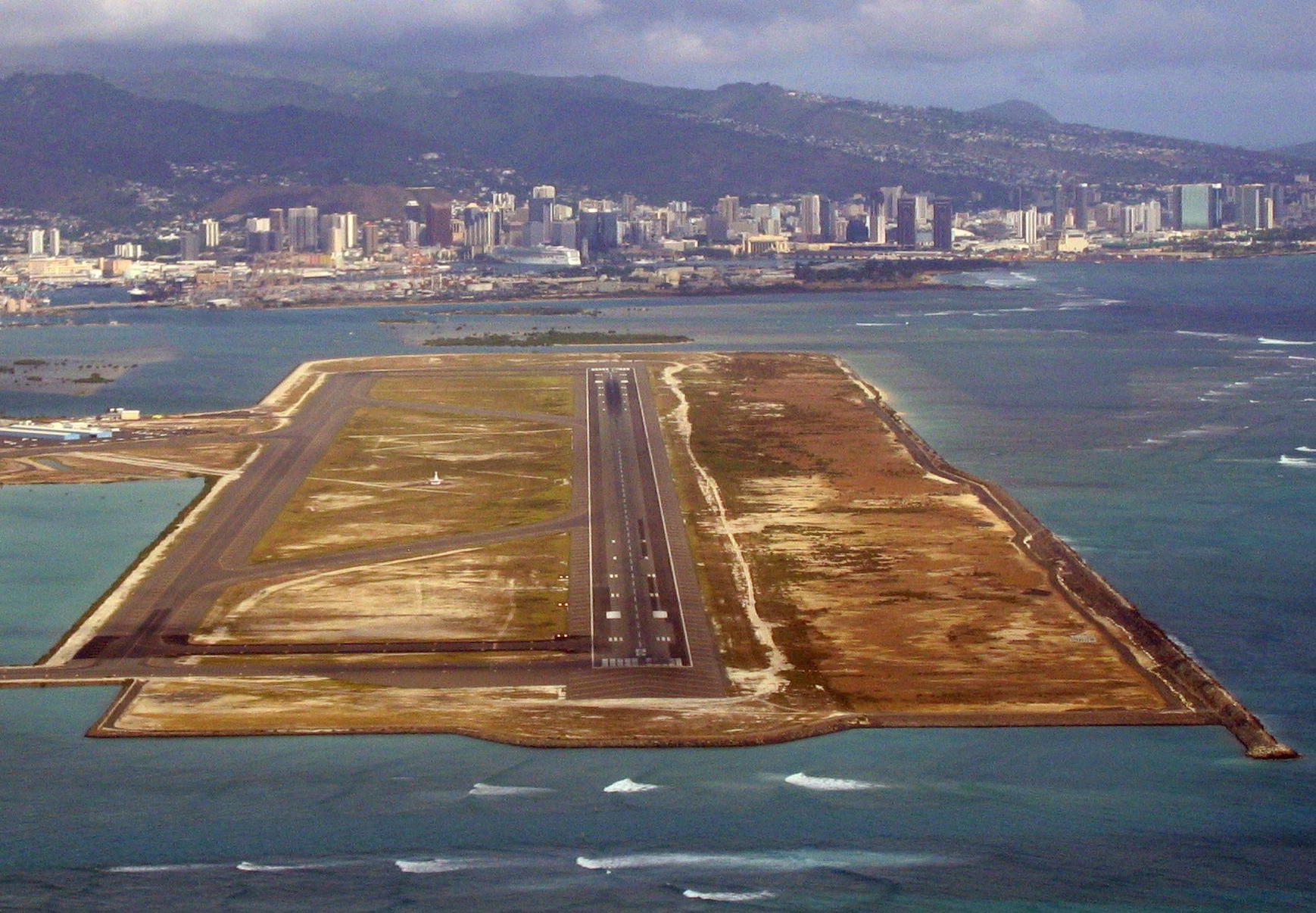 Honolulu International Airport has four major runways. The principal runway designated 8R/26L, also known as the Reef Runway, is the world's first major runway constructed entirely offshore. Completed in 1977, the Reef Runway is a designated alternate landing site for the National Aeronautics and Space Administration space shuttle program in association with Hickam Air Force Base, which shares Honolulu International Airport's airfield operations. (Courtesy of wikipedia.org)