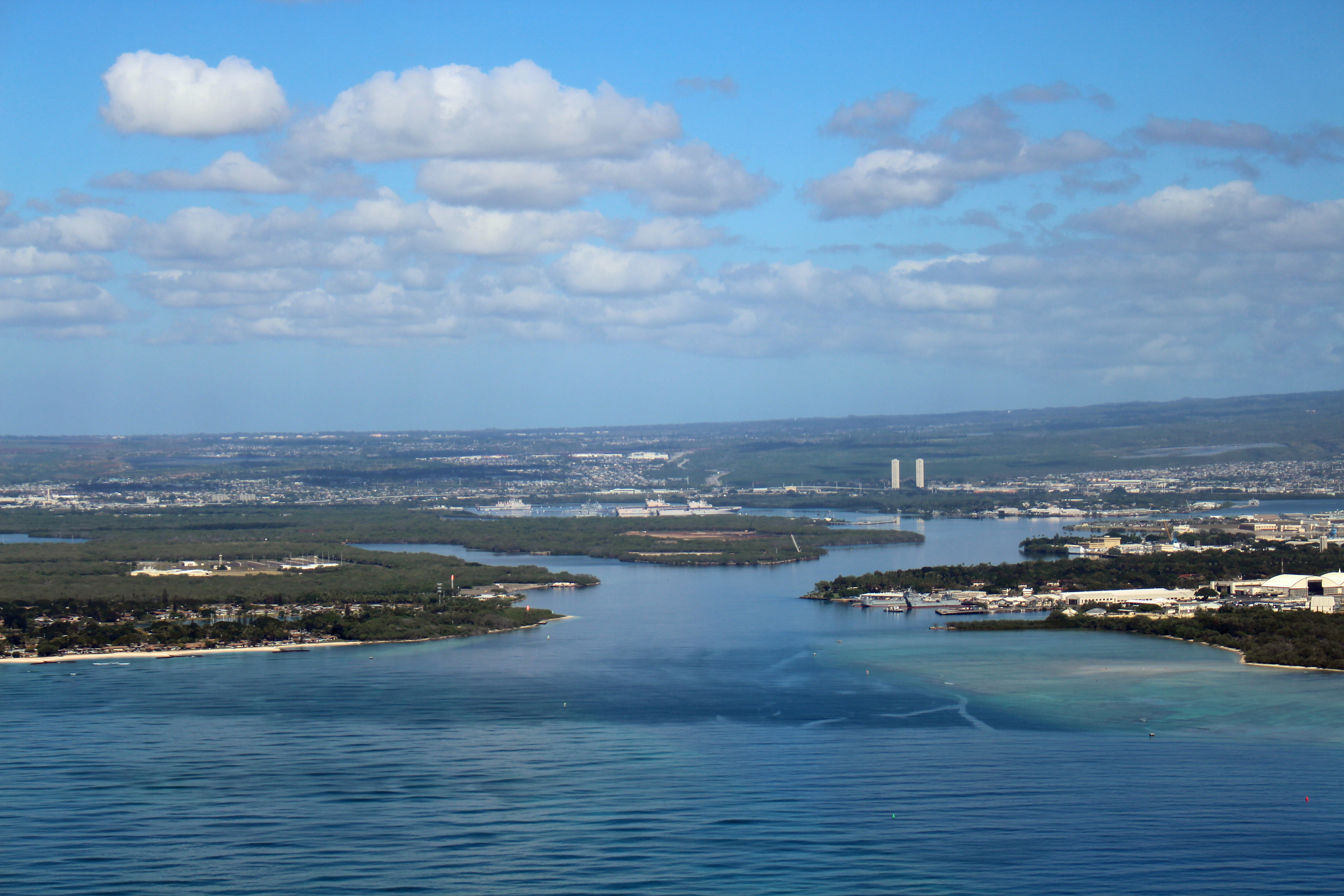 The entrance to Pearl Harbor in Honolulu, Hawaii as seen from a jetliner on final approach to Daniel K. Inouye International Airport. Photographed by user Coolcaesar on January 14, 2023.