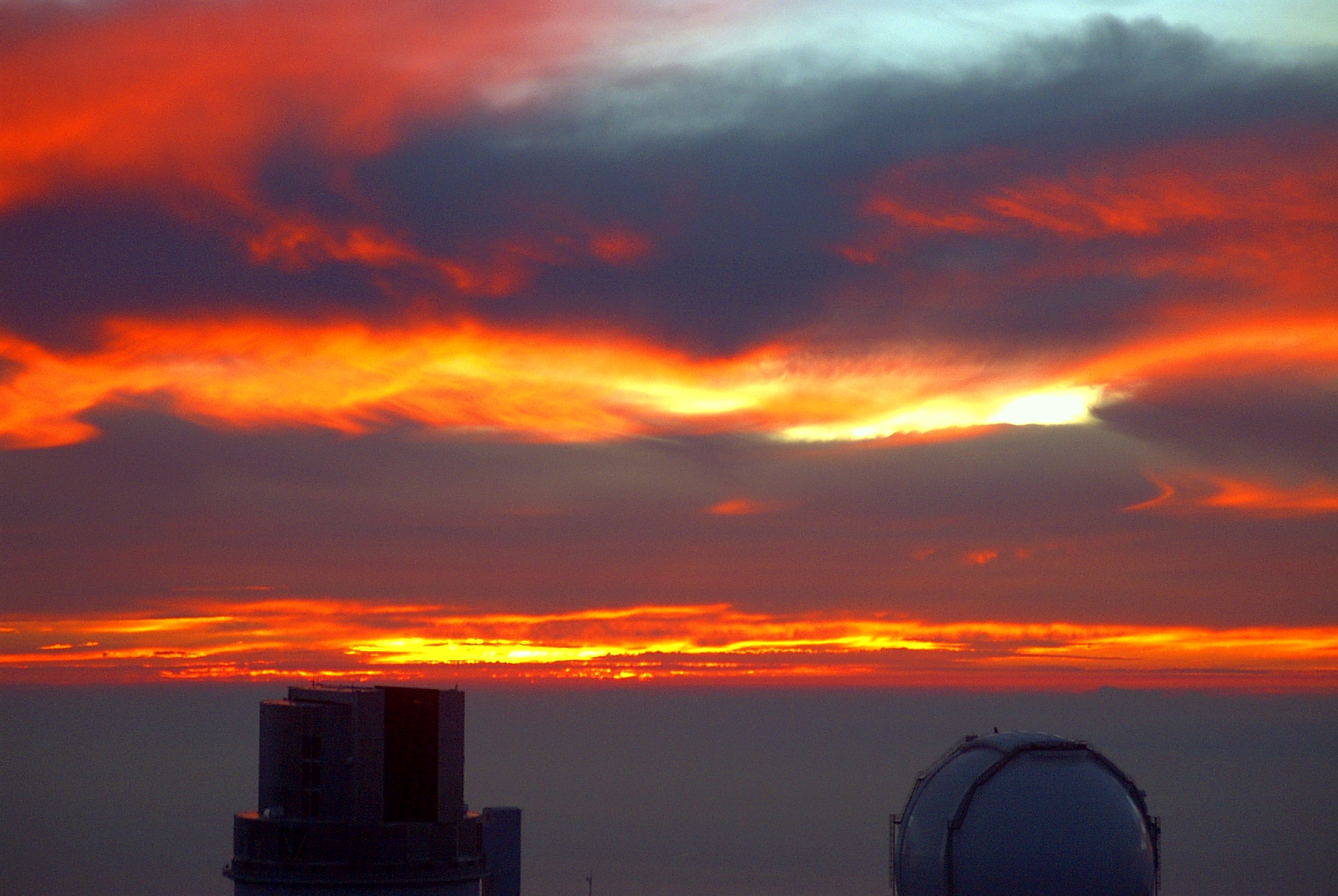 Sunset over Mauna Kea, Hawai'i. Visible is the Subaru Telescope and one of the telescopes of the W. M. Keck Observatory.