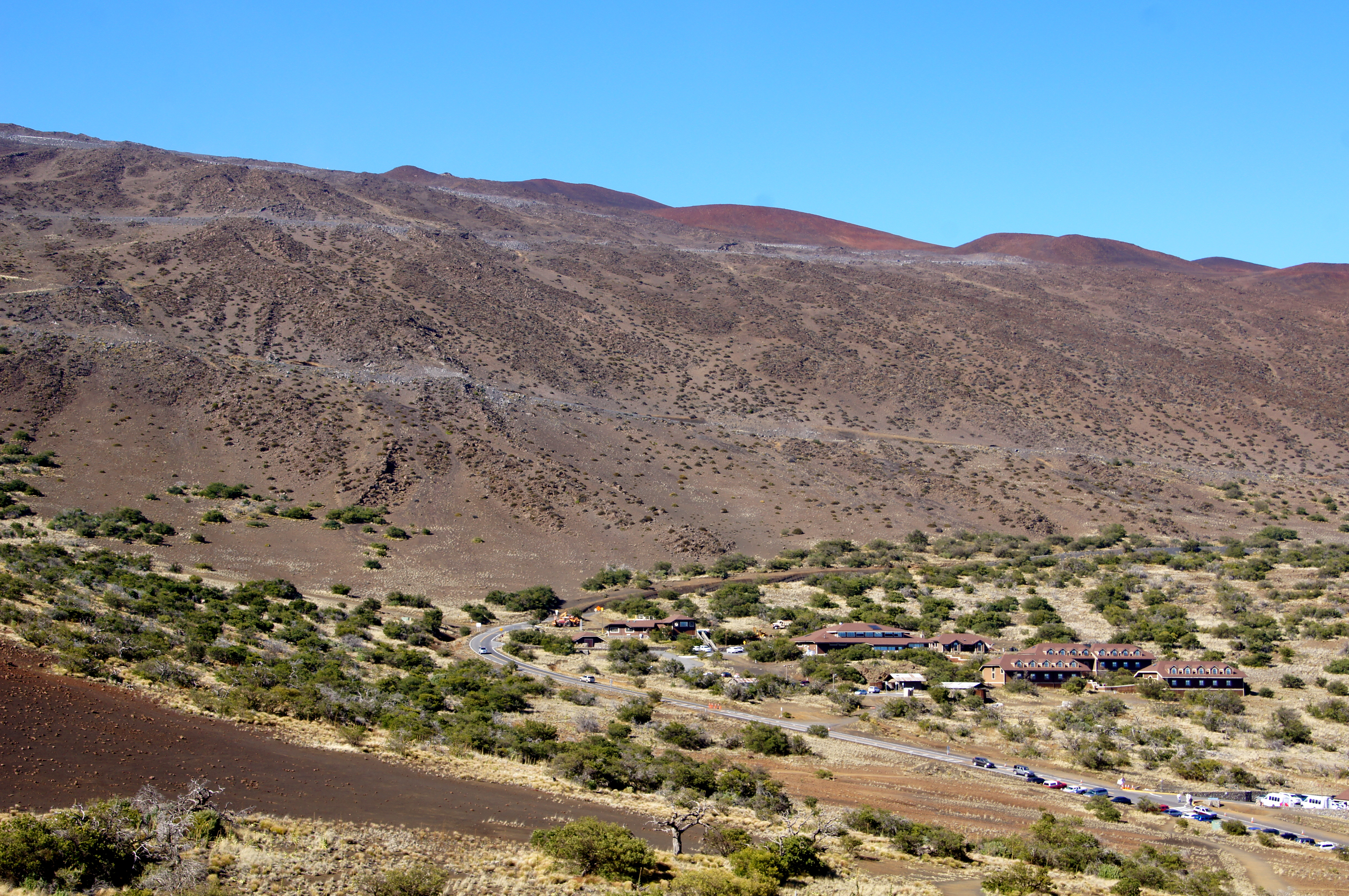A view of the Onizuka Center for International Astronomy Visitor Information Station on the ascent of Mauna Kea, taken from a Pu'u at the 9300 ft. level.