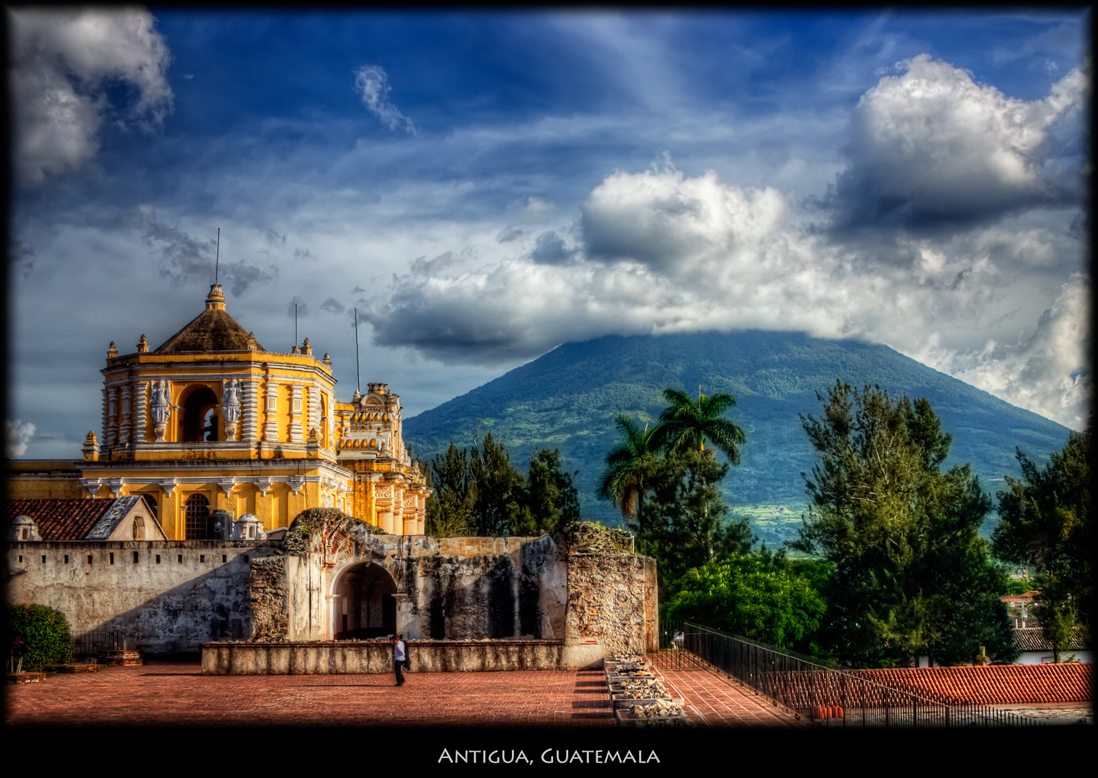 Volcan de Agua (Water Volcano) is one of three volcanos surrounding Antigua. I think the yellow building is one of the famous convents, and would appreciate it if someone tags the right name. This is pretty much what you come to Antigua for, beautiful buildings, the incredible surroundings and nice, friendly people. Nicer large.. See my Tikal shots.

ISO 100, 28mm, f7.1, 1/100. Tonemapped in Photomatix using Details Enhancer. Nik Pro Contrast, Tonal Contrast on the church and volcano, Vivezza to brighten the sky.