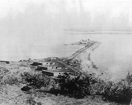 Ballast Point, near present-day San Diego, California.  Description at source states: "Battery Wilkeson. This view depicts Battery Wilkeson and Fetterman overlooking the 1890 lighthouse and whaler’s warehouses at the eastern tip of Ballast Point. The ruins of Fort Guijarros would be to the right of the largest gun battery, Battery Wilkeson. Source: Architect Milford Wayne Donaldson, FAIA, Inc. "