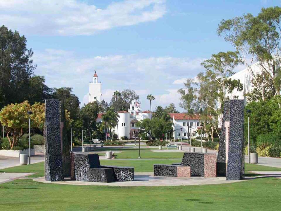 Campanile Mall extends north on Montezuma Mesa through the College Area of San Diego. Public artwork:   "100 Years 100 Stones" in foreground. (Hardy Memorial Tower in the distance)