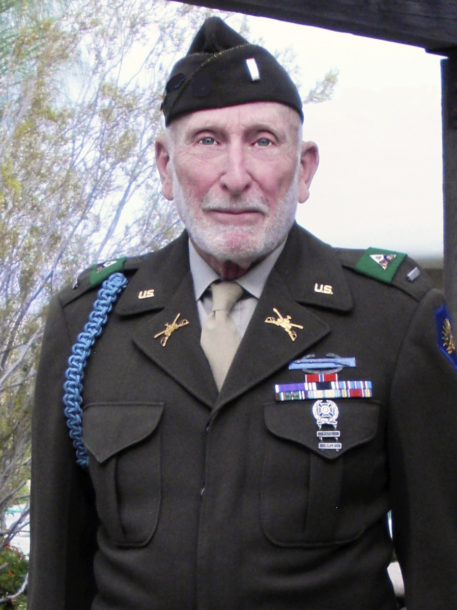 Donald Prell wearing a WWII garrison cap and “Ike” Jacket, but with insignia items (e.g., Armor insignia, expert rifle badge) and blue infantry cord that were not conceived of until years after WWII (photo from 2009)