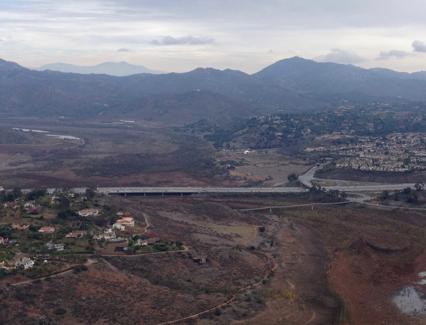 Lake Hodges Bridge (background) and David Kreitzer Lake Hodges Bicycle Pedestrian Bridge (foreground), over the nearly dry lake bed, in North San Diego County, California.  View is from Bernardo Mountain, facing east. Interchange is with Pomerado Road on the east side and Bernardo Drive on the west side.