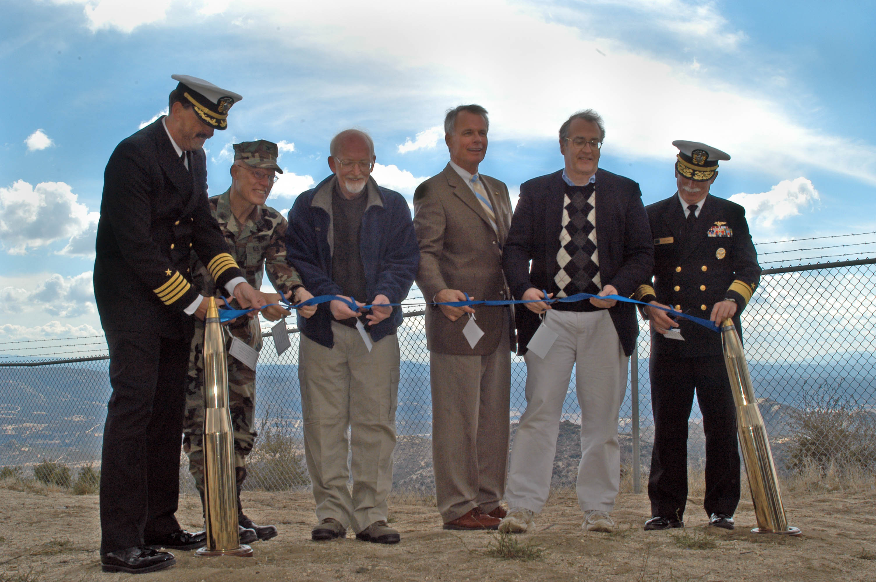 La Posta, Calif. (Feb. 21, 2006) - Assistant Under Secretary of Defense, Alex A. Beehler; California Secretary for Resources, Mike Chrisman; Deputy Commander 3rd Fleet, Rear Adm. John R. Hines Jr., and retired U.S. Army Brig. Gen. Bob Barnes participate in a ribbon cutting ceremony to commemorate the purchase of land by the U.S. Navy. This purchase will expand to the current acreage of the Navy Mountain Warfare Training Facility and will also be used as a wildlife refuge. U.S. Navy photo by Photographer’s Mate Airman Brian Gaines (RELEASED)