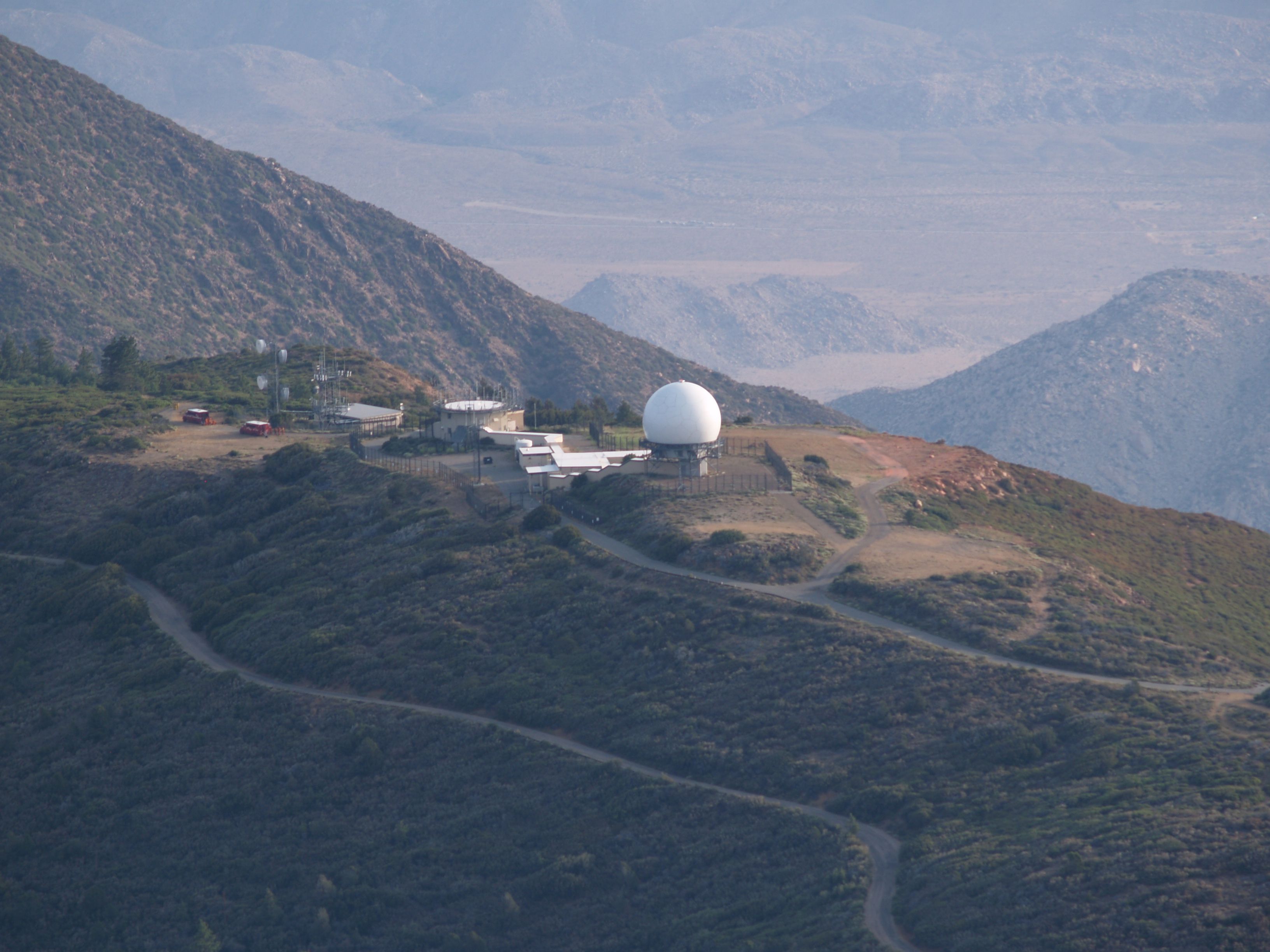 Photo of the Mt. Laguna FAA Station (formerly USAF Station) taken during the Chariot Fire. Two fire vehicles can be seen parked nearby to defend the area.