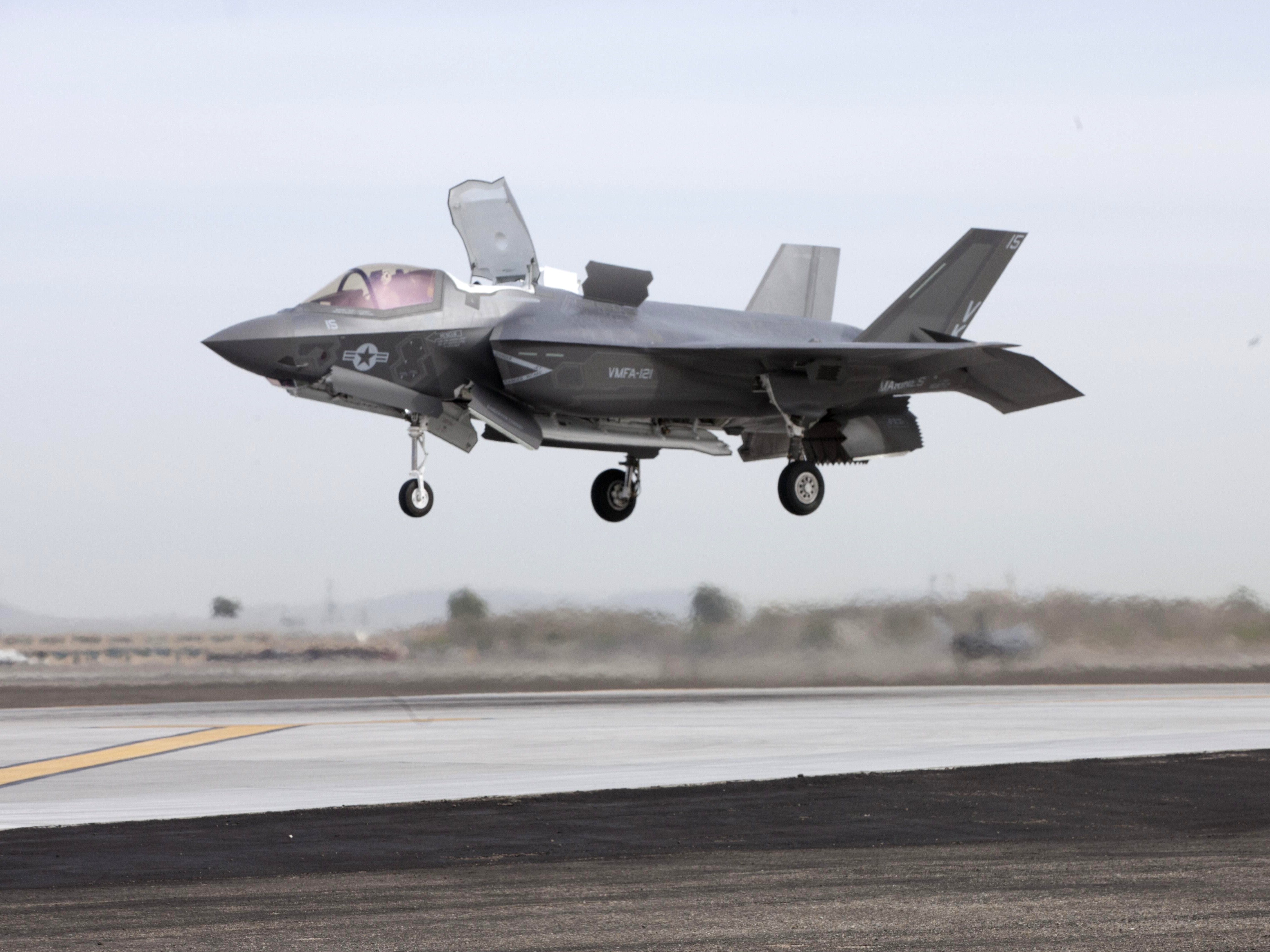 A U.S. Marine Corps Lockheed Martin F-35B Lightning II from Marine Fighter Attack Squadron 121 (VMFA-121) conducts a vertical landing on the Marine Corps Air Station Yuma, Arizona (USA), flightline on 21 March 2013. "VK-15", piloted by Maj. Richard Rusnok, an F-35B test pilot, conducted the first short take off, vertical landing outside of a testing environment.