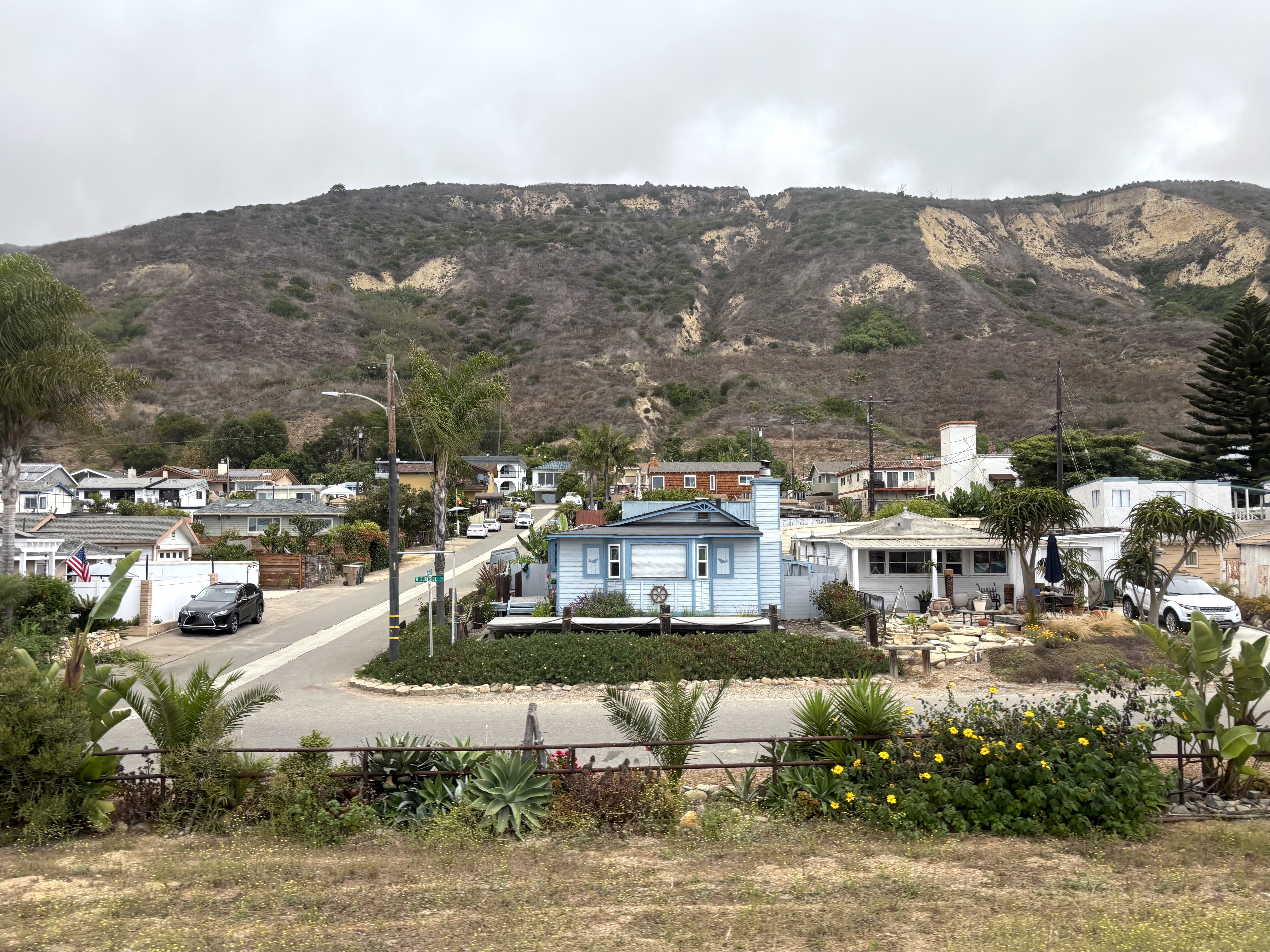 View of houses in the coastal community of La Conchita in Ventura County, California, as seen from the Coast Starlight Amtrak train.
