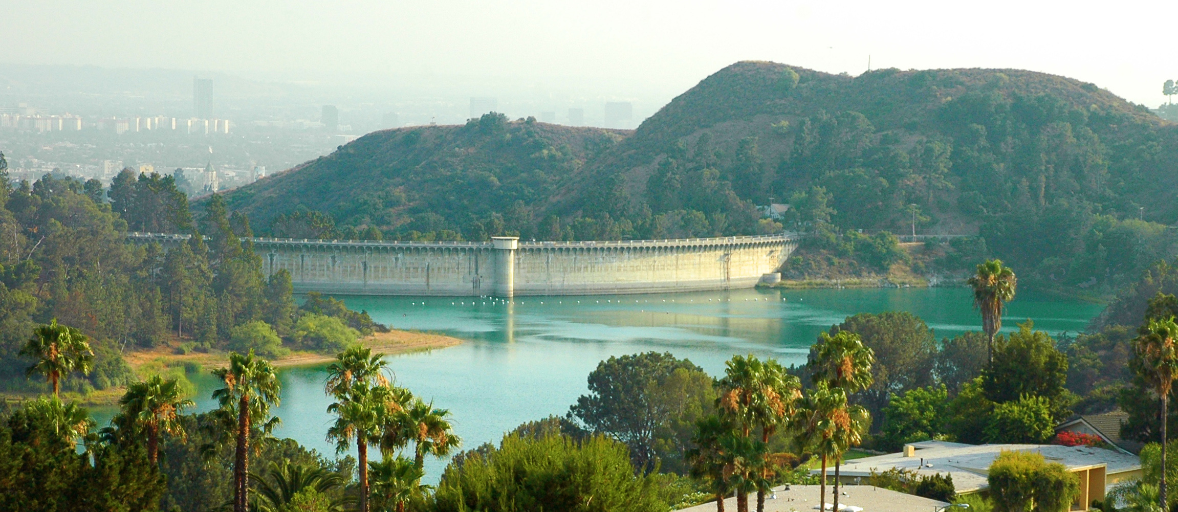 A view of Hollywood Reservoir and the back side of the Mulholland Dam — viewed from Canyon Lake Drive, Los Angeles, California.
In the Hollywood Hills (eastern Santa Monica Mountains).
Credits
This image differs from the original digital photograph in that it has been cropped and the color balance, saturation, and contrast have been modestly adjusted.