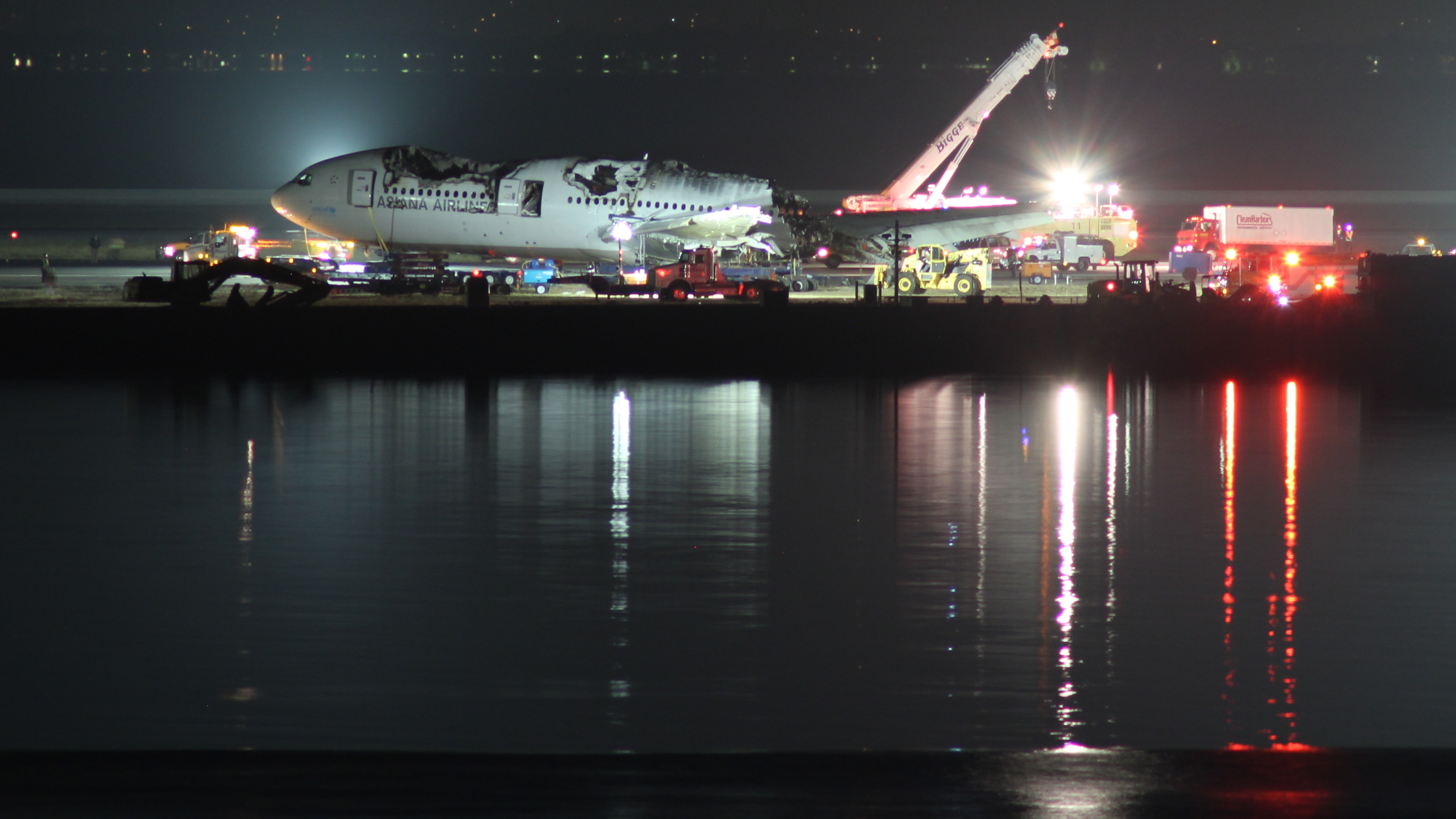 Crews work through the night to remove the fuselage of a destroyed Boeing 777-200ER from a field adjacent to Runway 28L at San Francisco International Airport (SFO). Asiana Airlines flight 214 crash landed at SFO on 6 July 2013.