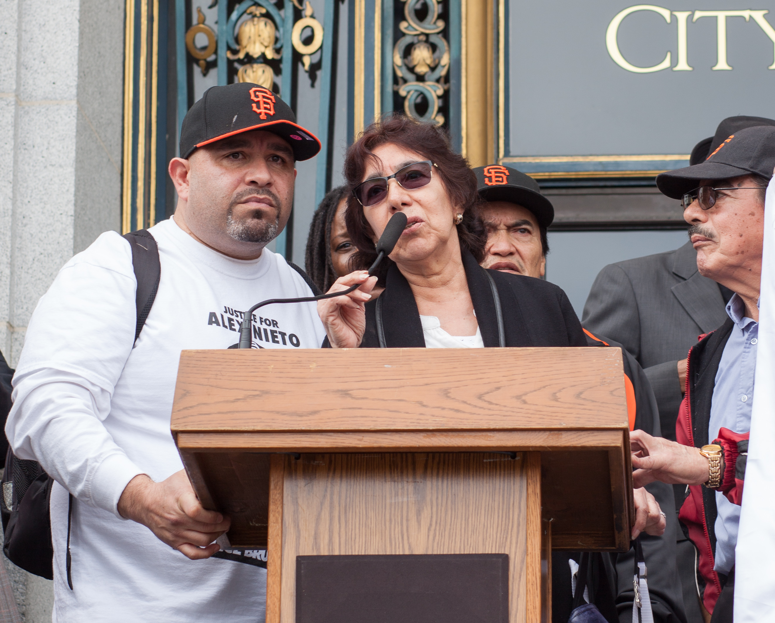 Elvira Nieto, mother of the slain Alex Nieto, speaks at a podium on the steps of San Francisco City Hall.