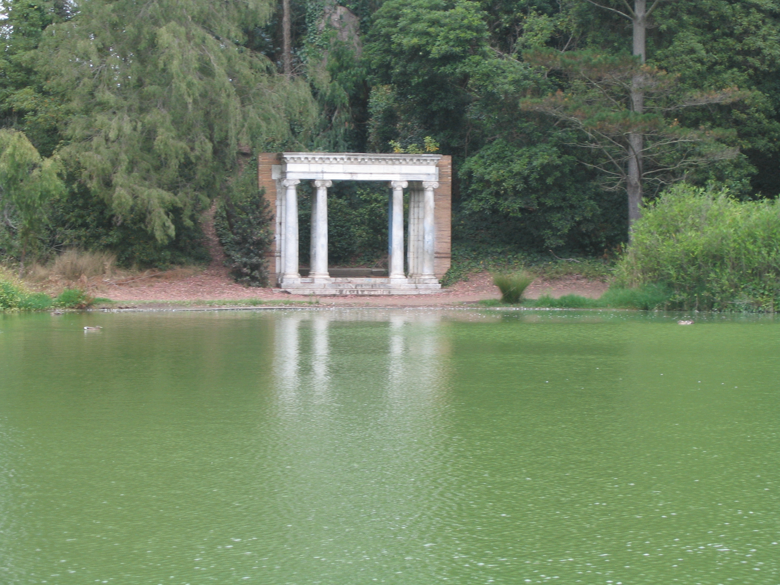 Lloyd Lake. This is a front porch standing without a house — all that remains of a Nob Hill house destroyed in the 1906 earthquake. 

It is the only public memorial to the disaster in the City, and is on the lake in Golden Gate Park.
The Neoclassical portal is sited as an architectural folly, a traditional element in the English landscape garden style.