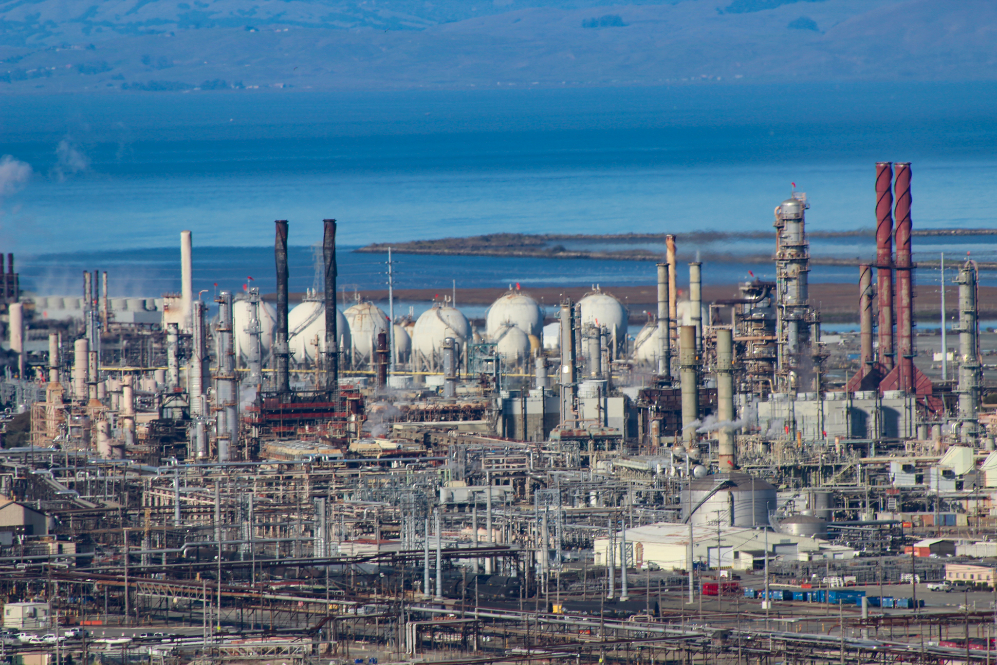 Detail of Chevron Richmond Refinery with backdrop of San Pablo Bay, taken from Nicholl Knob in of  Miller/Knox Regional Shoreline Park