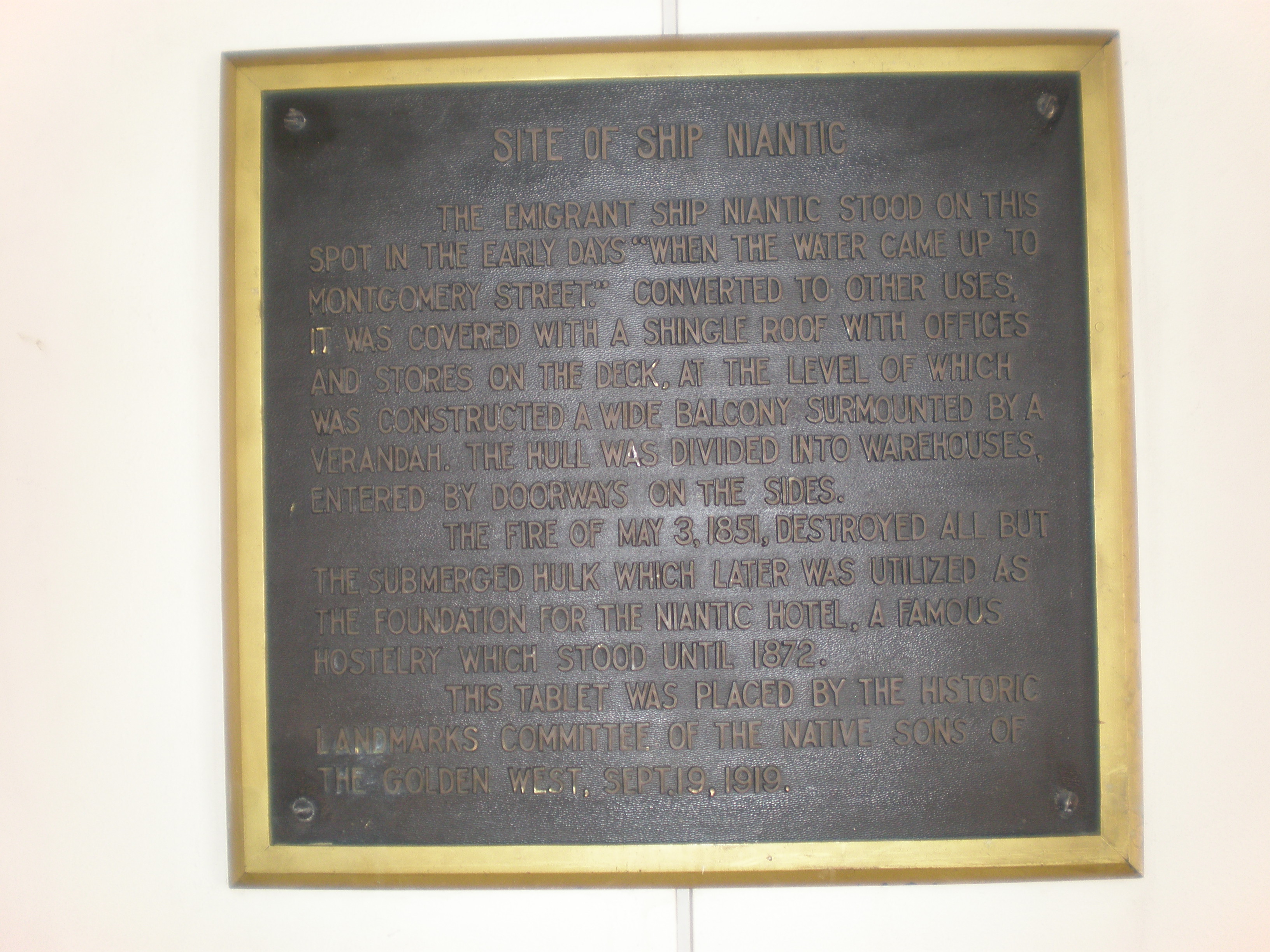 A plaque marking the location of the ship Niantic at the intersection of Clay and Sansome Streets in San Francisco.