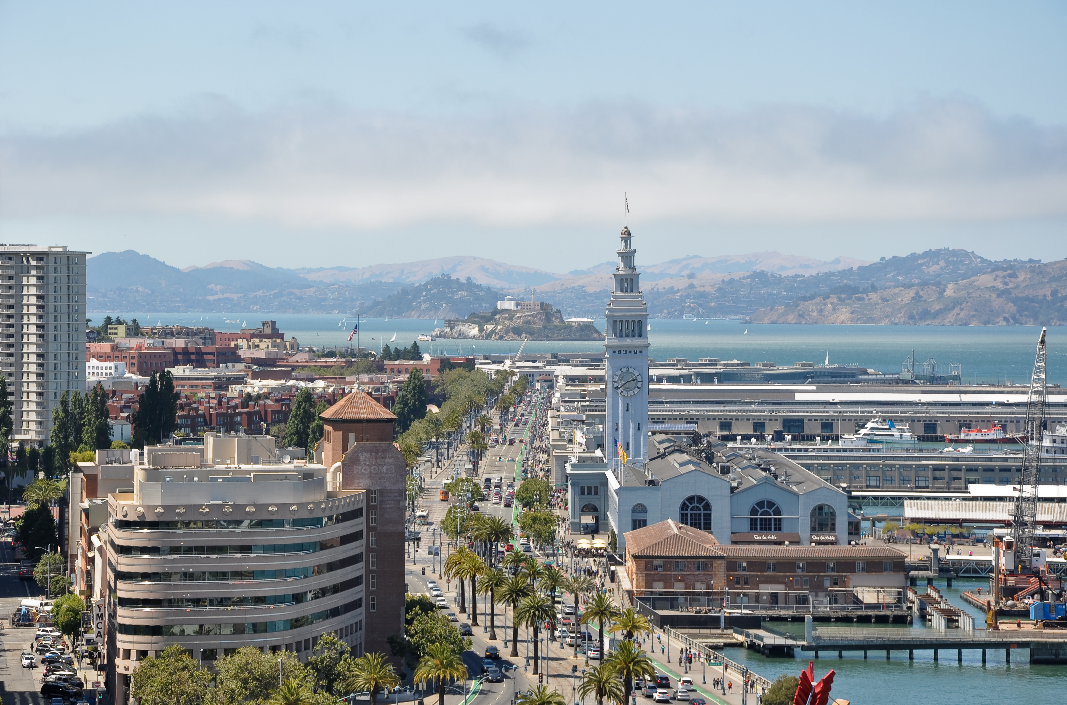A view of the Embarcadero in San Francisco, with the Ferry Building at the right and Alcatraz Island in the background.