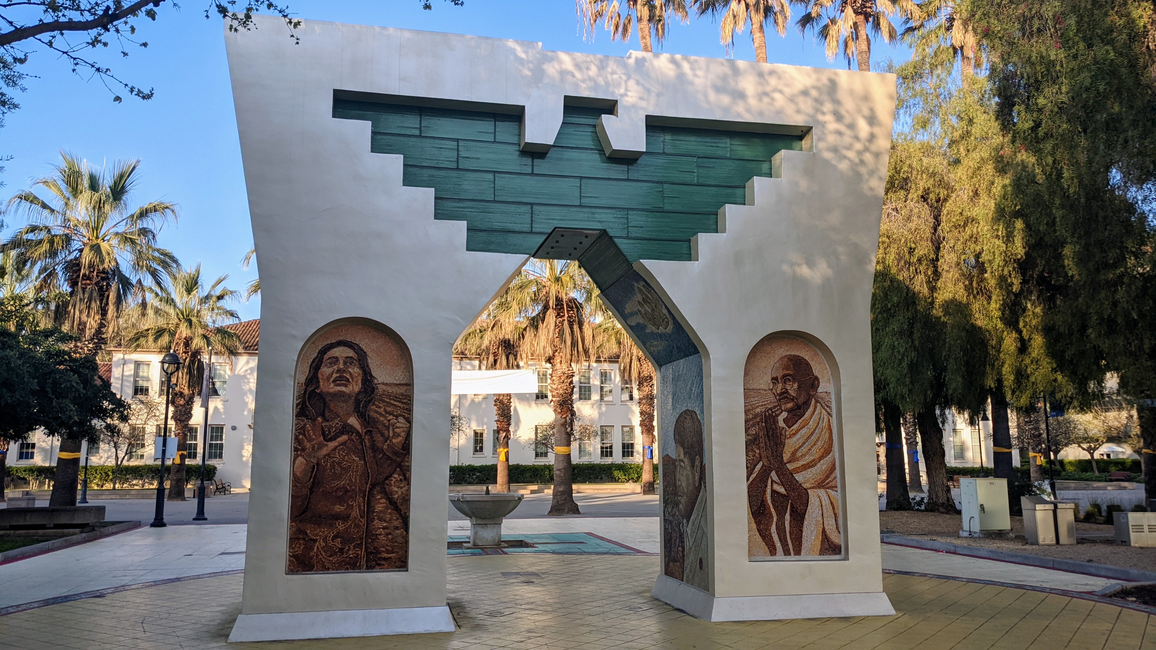 This monument in commemoration of the life of Cesar Chavez lives on the campus of San Jose State University in downtown San Jose, California. The arch is capped by an eagle, the symbol of the United Farm Workers, and includes mosaic murals of Cesar Chavez and Dolores Huerta to celebrate their victories for California farm workers with 
a Mahatma Gandhi, Chavez' inspiration, mosaic as well. The circular mosaic path is treated with colors derived from the four Maya pre-Hispanic Codices discovered to date: Dresden, Paris, Madrid and Grolier. The arch stands in the middle of the passageway, representing the students going from having a vision to becoming an activist.
