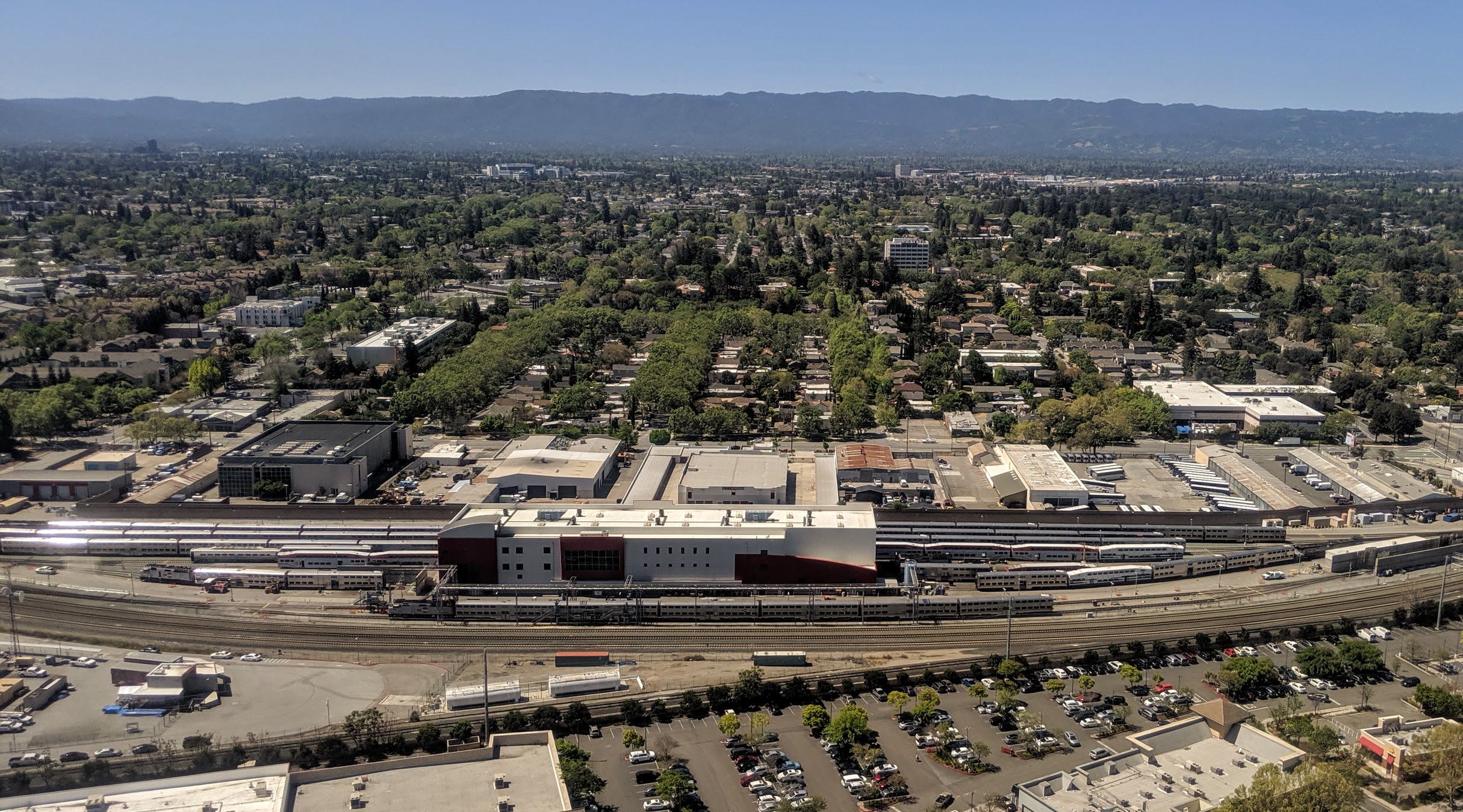 Aerial view of the Caltrain Centralized Equipment Maintenance and Operations Facility (CEMOF) in San José, California, on landing at SJC