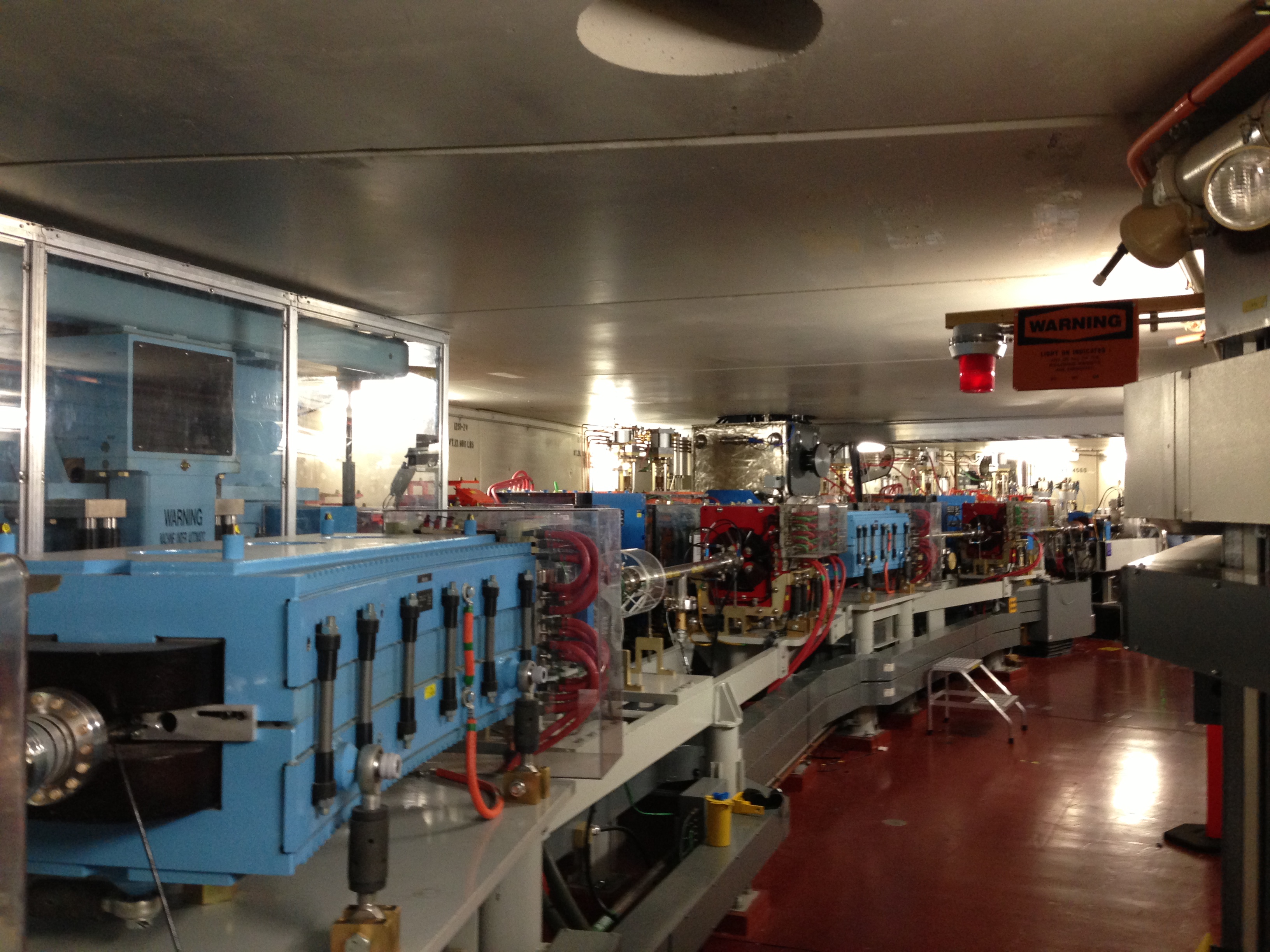 Inside the storage ring at the Advanced Light Source, Lawrence Berkeley National  Laboratory. Large magnets bend, steer, and focus the electron beam as it circles the ring 1.4 million times per second.