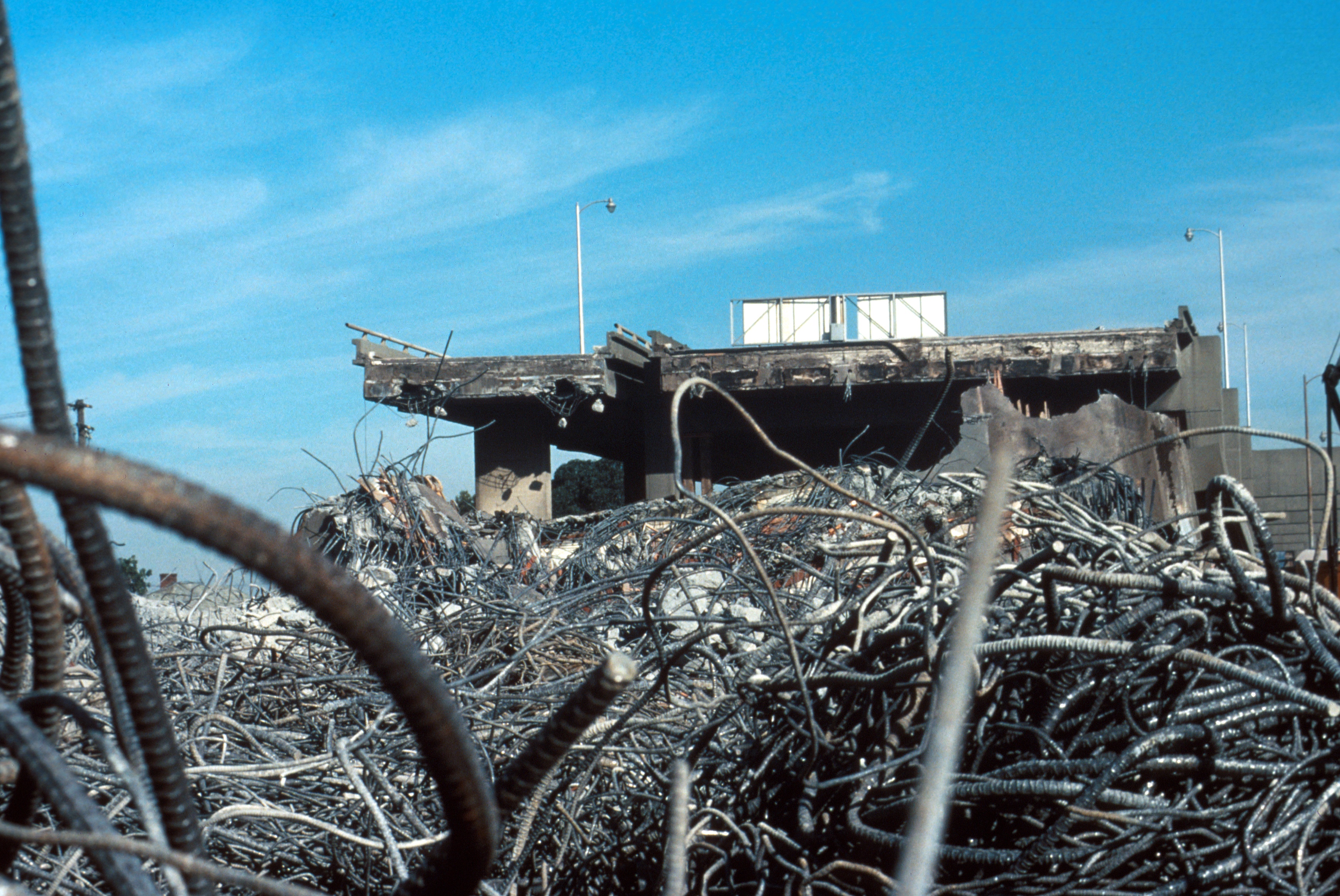 Loma Prieta, California, Earthquake October 17, 1989. Oakland. Reinforcement bars lie at the base of the Cypress viaduct of Interstate 880 near 14th Street. Slide III-3, U.S. Geological Survey Open-File Report 90-547.