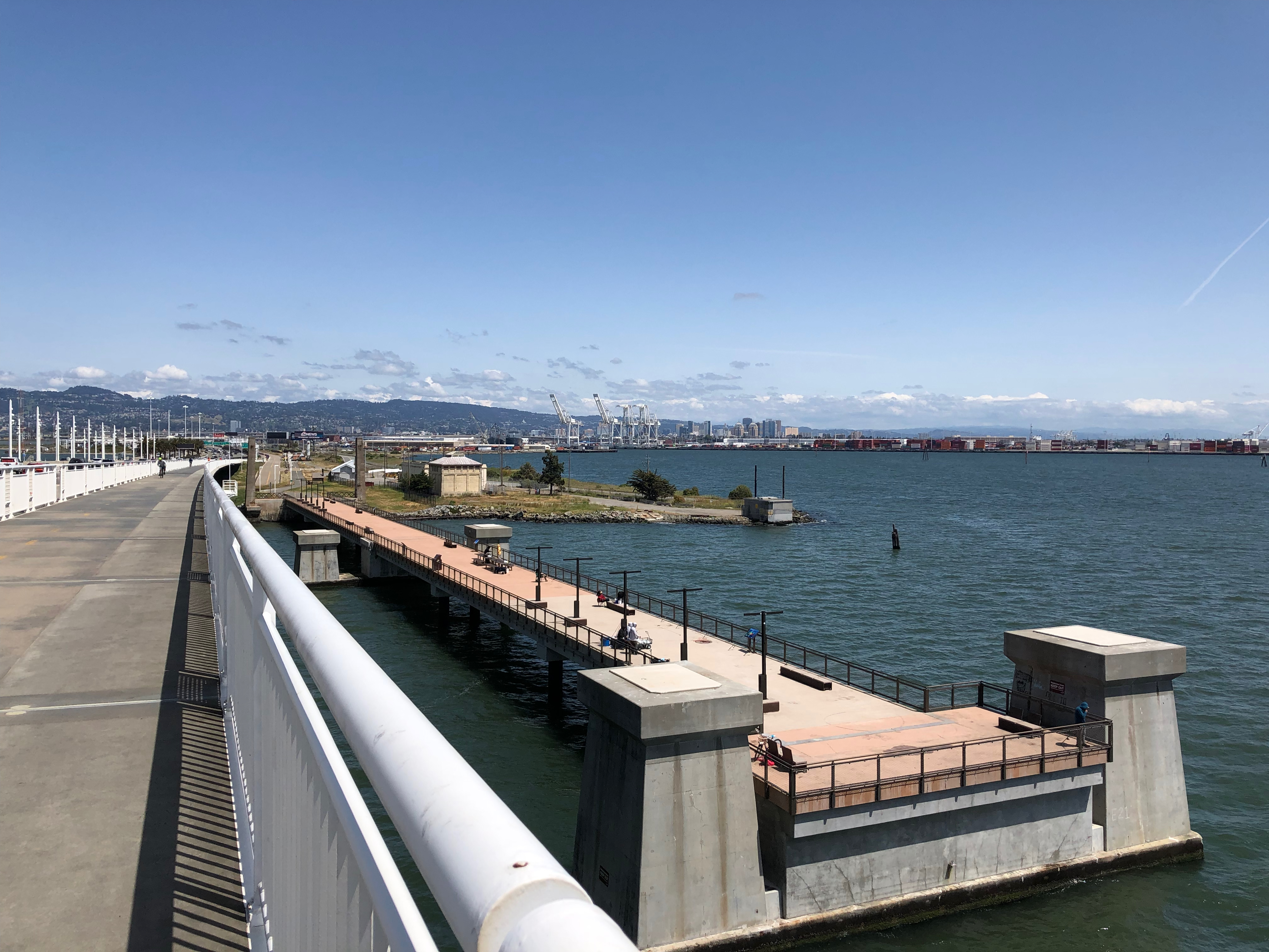 The Observation Pier at Judge John Sutter Regional Shoreline. The Port of Oakland is visible in the background on the right. The bike/pedestrian path on the south side of the San Francisco-Oakland Bay Bridge is visible on the left side of the photo.