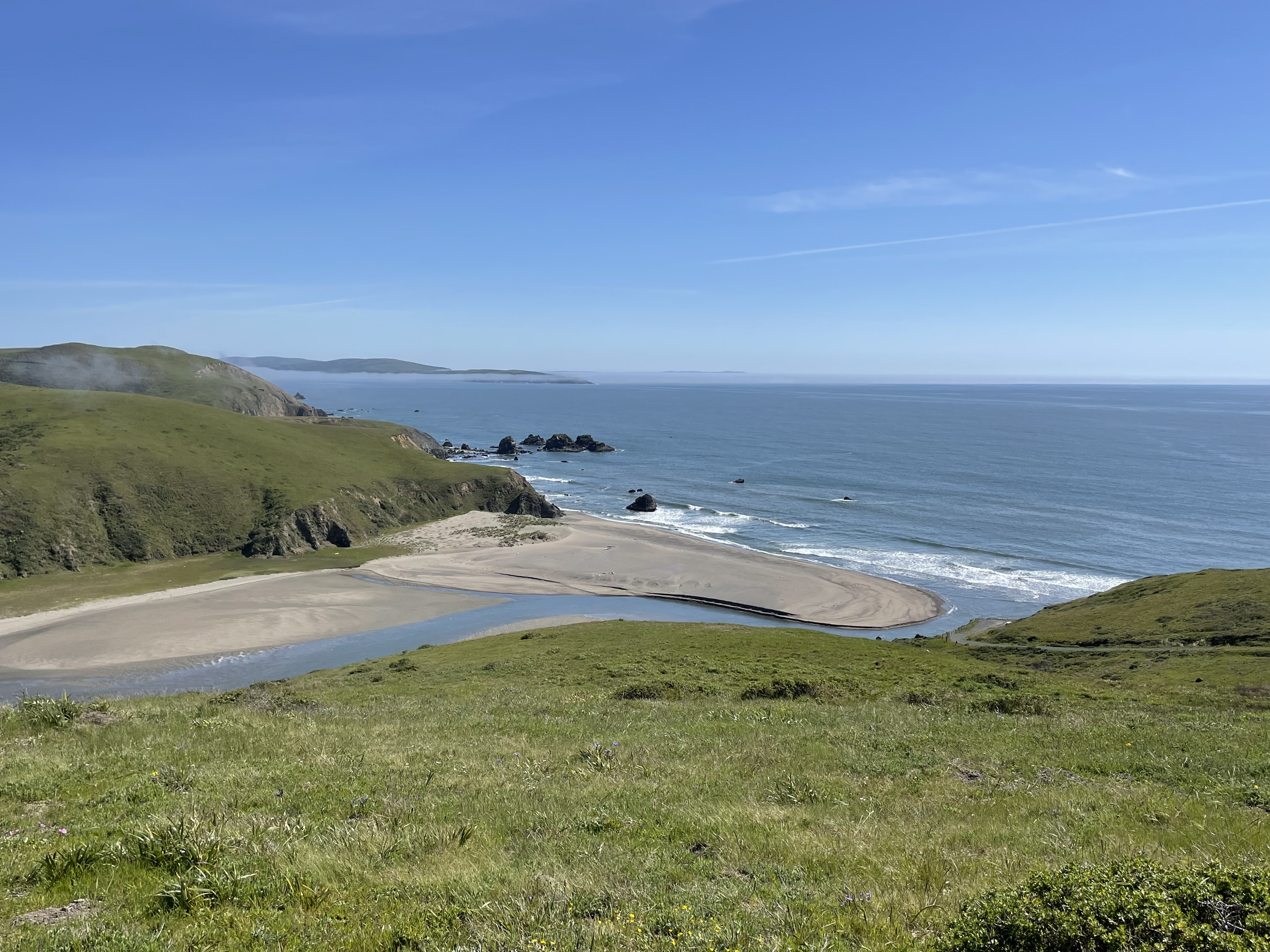 This is the Estero Americano estuary as it reaches the Pacific Ocean. The view is from The Wildlands Conservancy Estero Americano Coast Preserve. The estuary separates Sonoma and Marin counties.