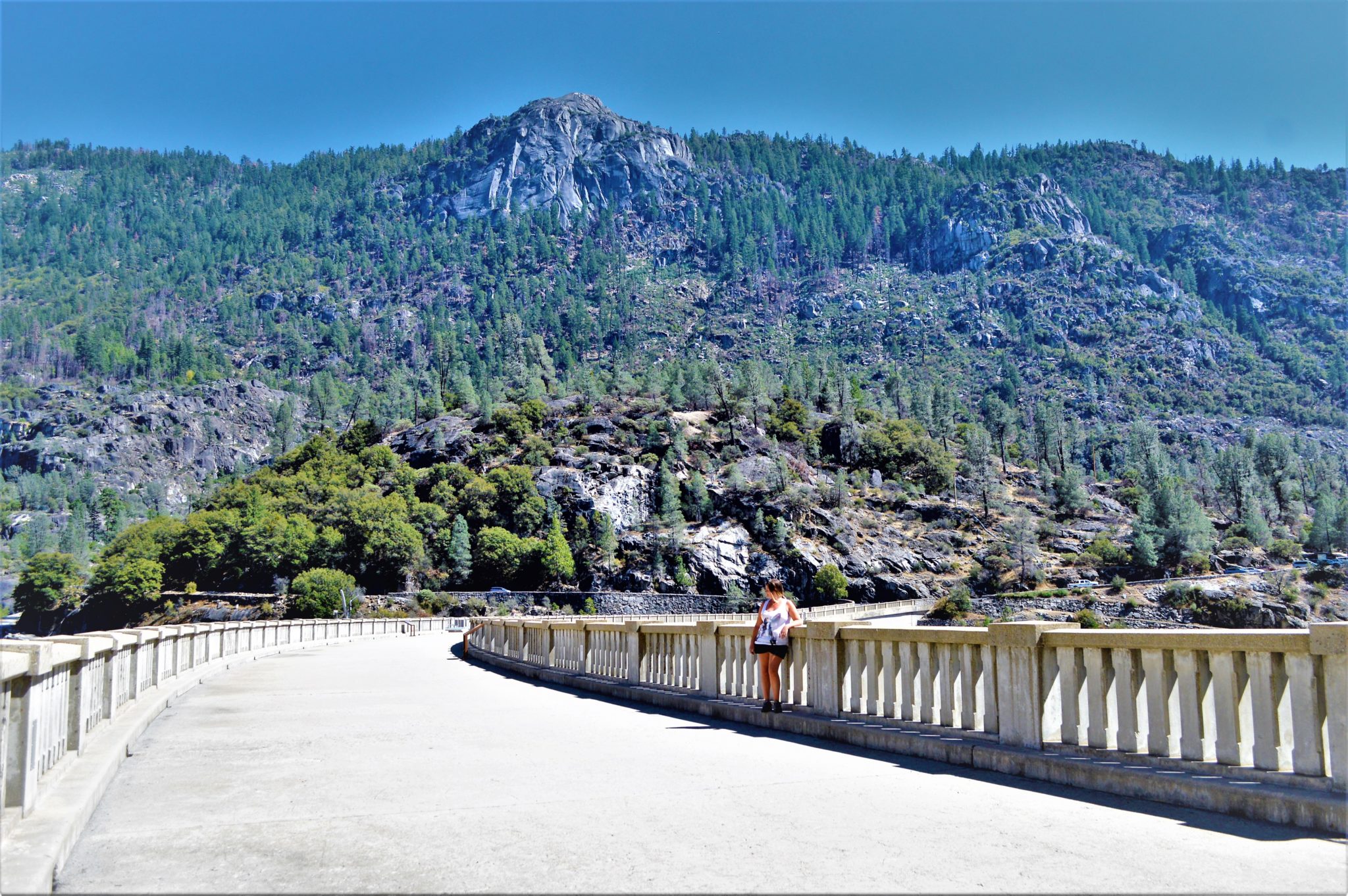 On top of the O’Shaughnessy Dam in Hetchy Hetchy Park in California. There is a walkway on top of the dam that allows pedestrian crossing with railings that serve also as a viewpoint.