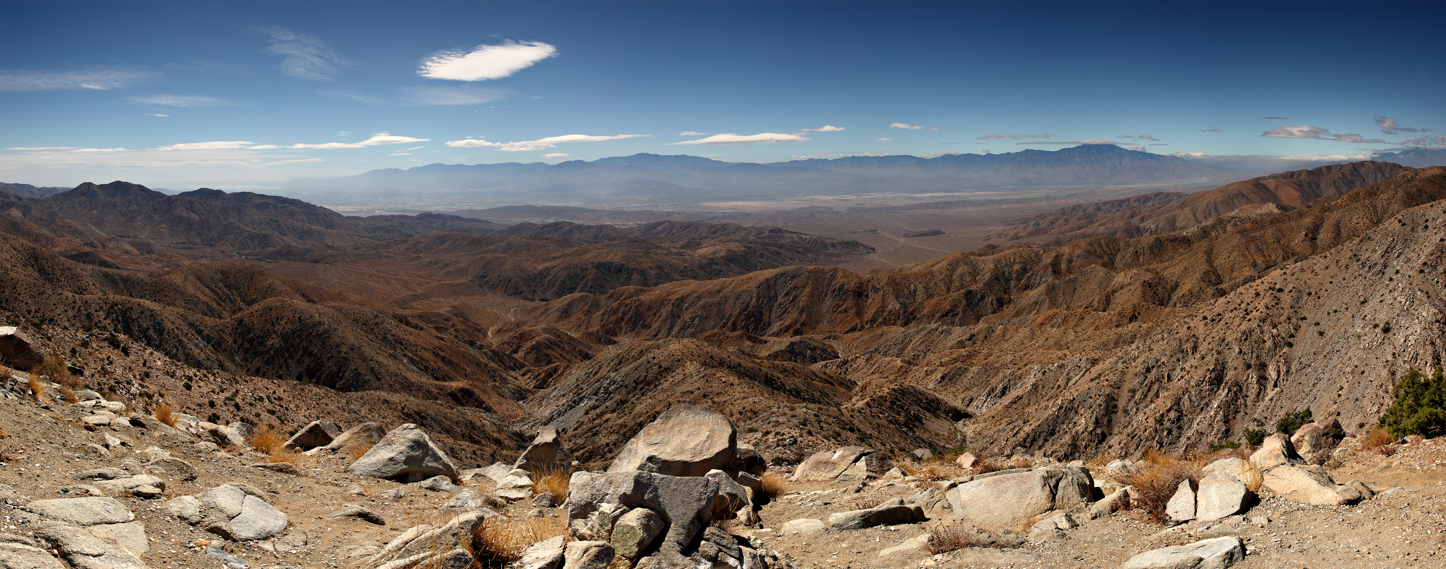 Panorama of the view south from Keys View in the Little San Bernadino Mountains, Joshua Tree National Park, California.
Visible landmarks are the Salton Sea (230ft below sea level) at rear left, along towards the center the Santa Rosa Mountains behind Indio and the San Jacinto Mountains behind Palm Springs.
In the valley floor, the San Andreas Fault is visible. At the rear right is the 11,500 ft Mount San Gorgonio.