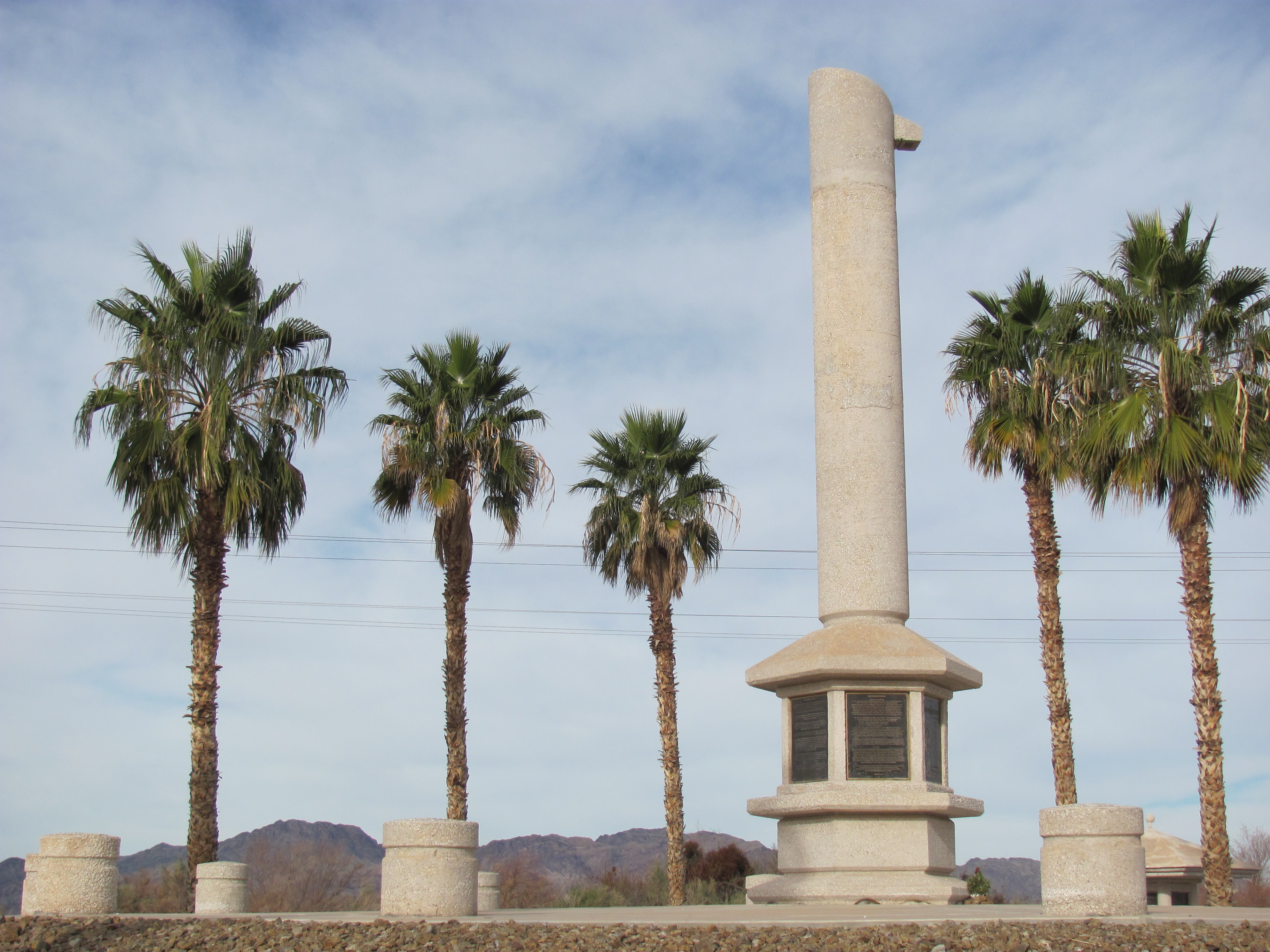 Poston War Relocation Center Memorial Monument. (A high resolution, expandable photo). Note:, shadows show about a noon-time photo looking approximately northwest; the mountains shown are therefore a northern section of the 7-mi long (11-km) Riverside Mountains. The Memorial is located about 1 mi south of Poston, Arizona center, and about the center region of the Parker Valley. The Memorial is about 5-mi from the Riverside Mountains.