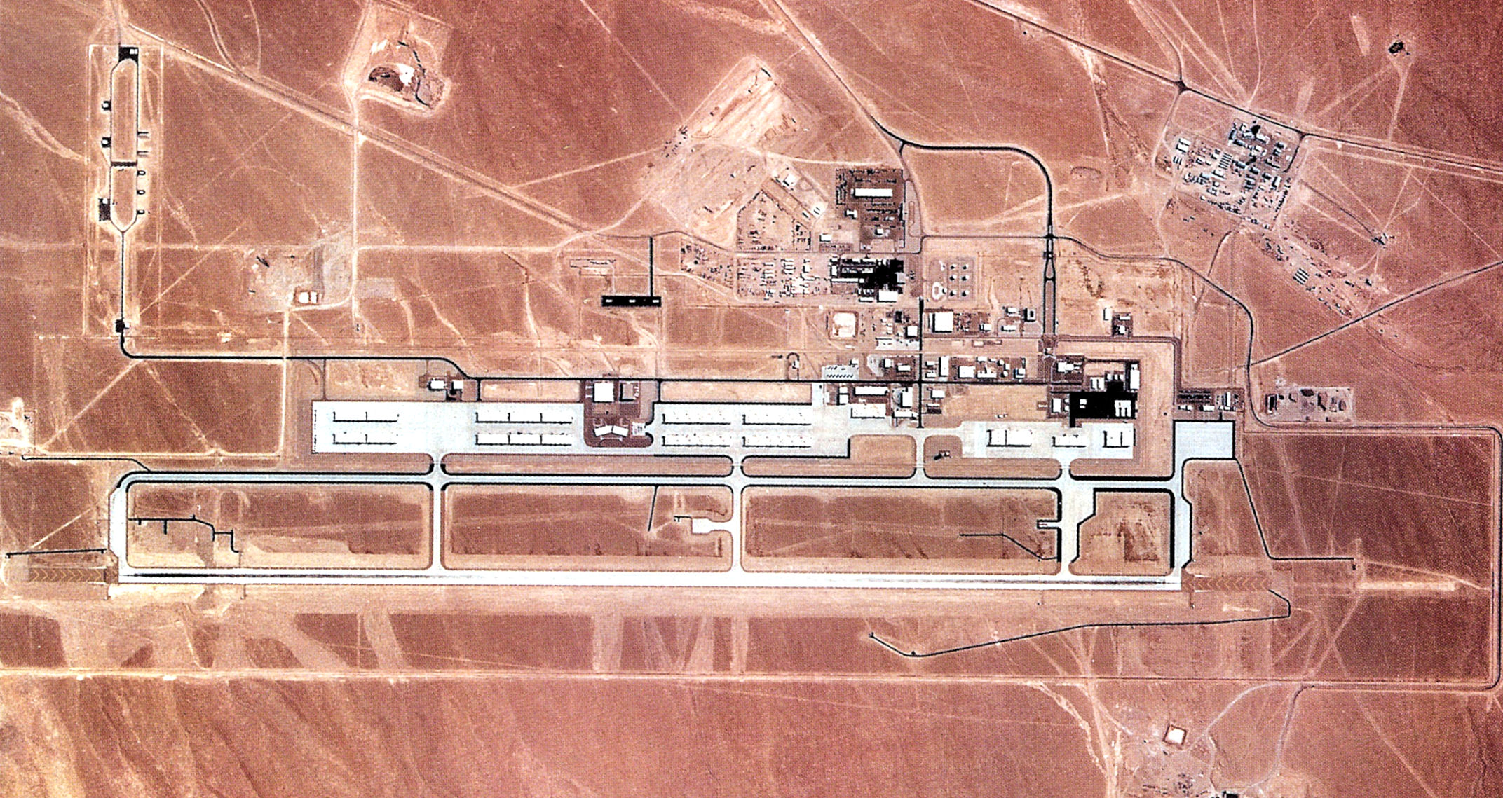 Tonopah Test Range Airport, 1990, when the USAF 37th Tactical Fighter Wing was stationed at the airport, note the F-117A hangars.    Today, these hangars are used for long term storage of the Nighthawk stealth fighter