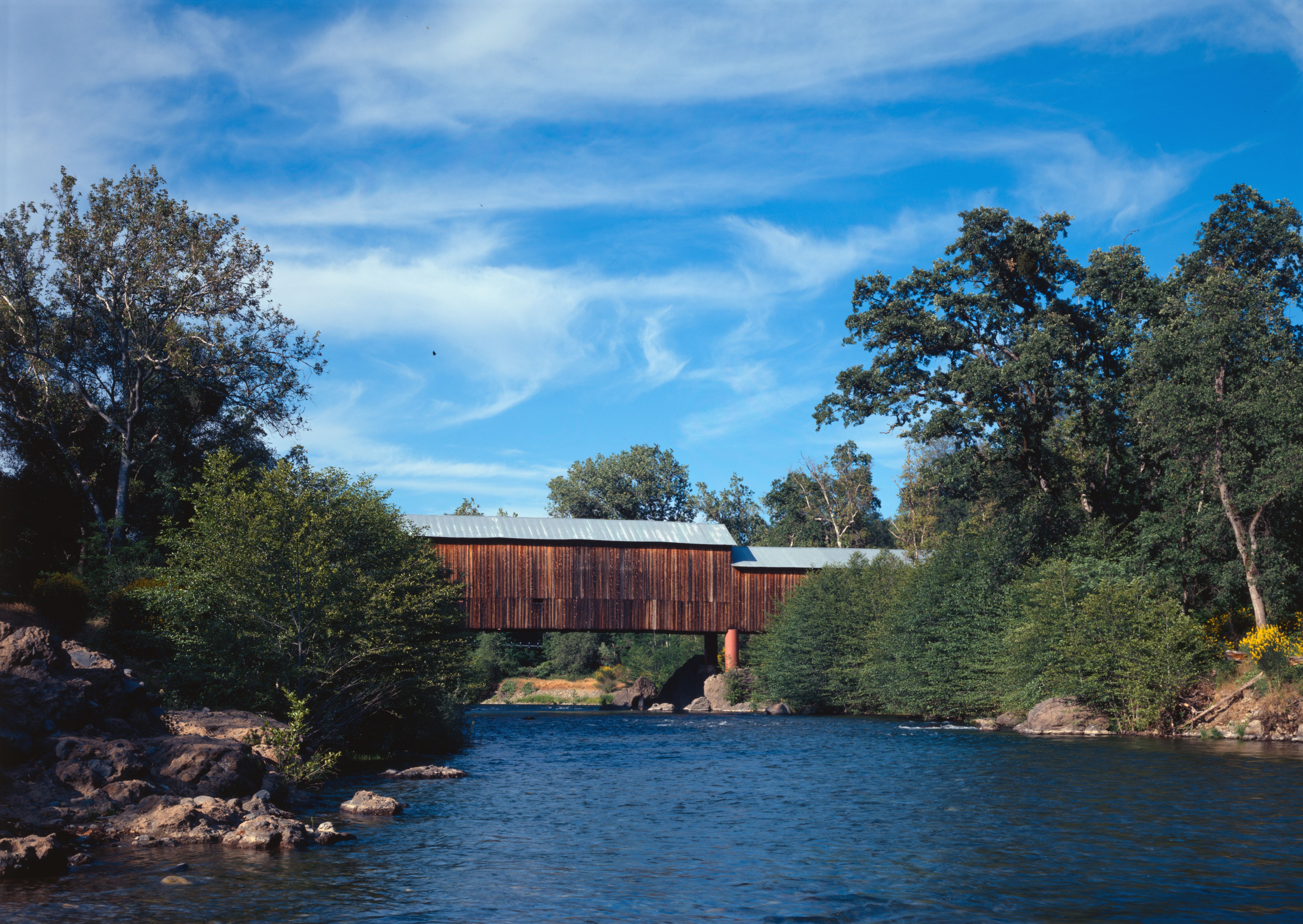 The Honey Run Covered Bridge — spanning over Butte Creek, in northern Butte County, California. 
Built in 1886, and covered in 1894. Listed on the National Register of Historic Places in Butte County.
Image (2004): HAER—Historic American Engineering Record images of California.