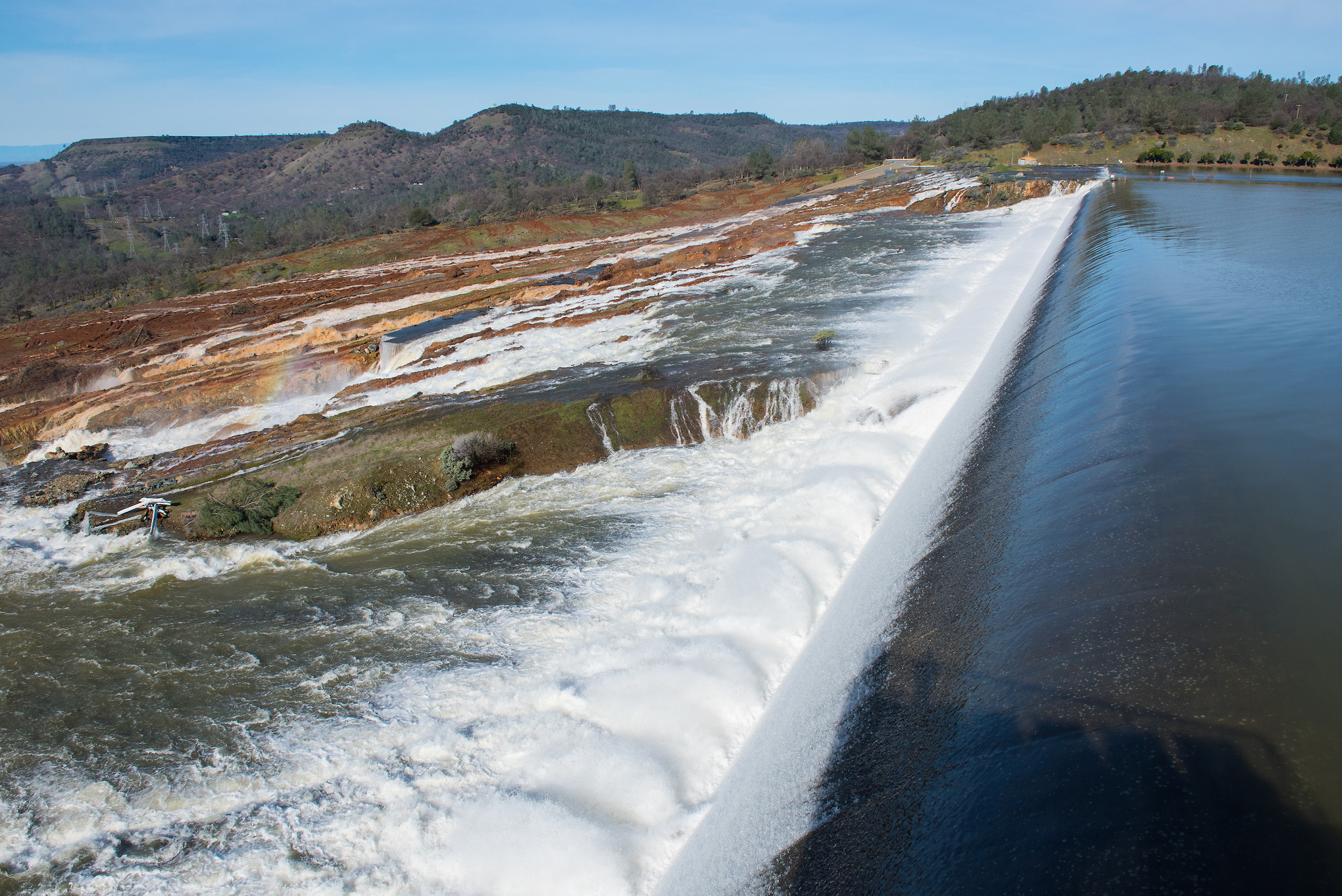 Water from the Oroville Dam flows over the Emergency Spillway at Lake Oroville on Sunday February 12, 2017.
