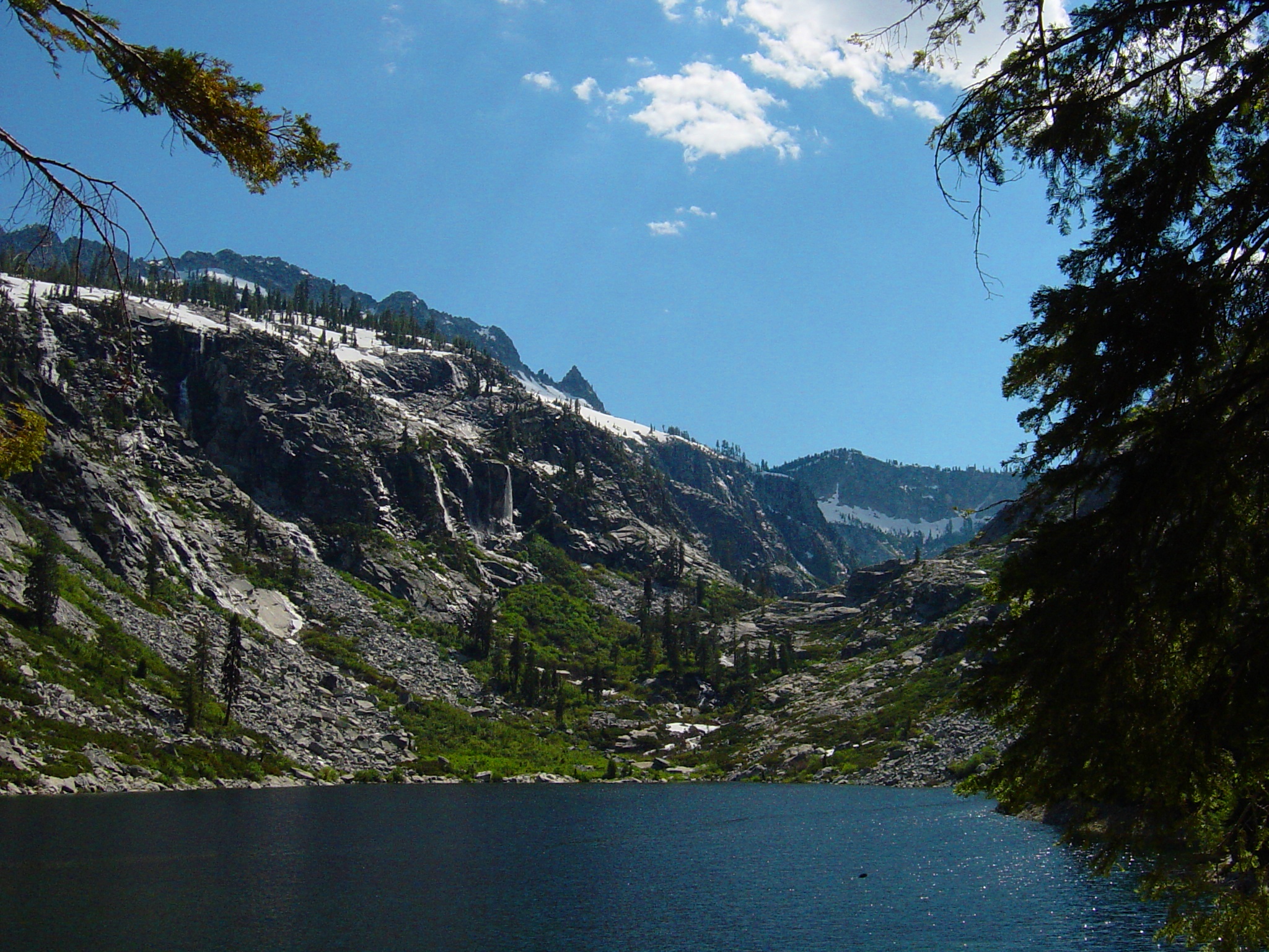 An alpine lake with waterfalls from the granite cliffs, high in the Trinity Alps Wilderness.
In the Trinity Alps—Klamath Mountains, northern California.