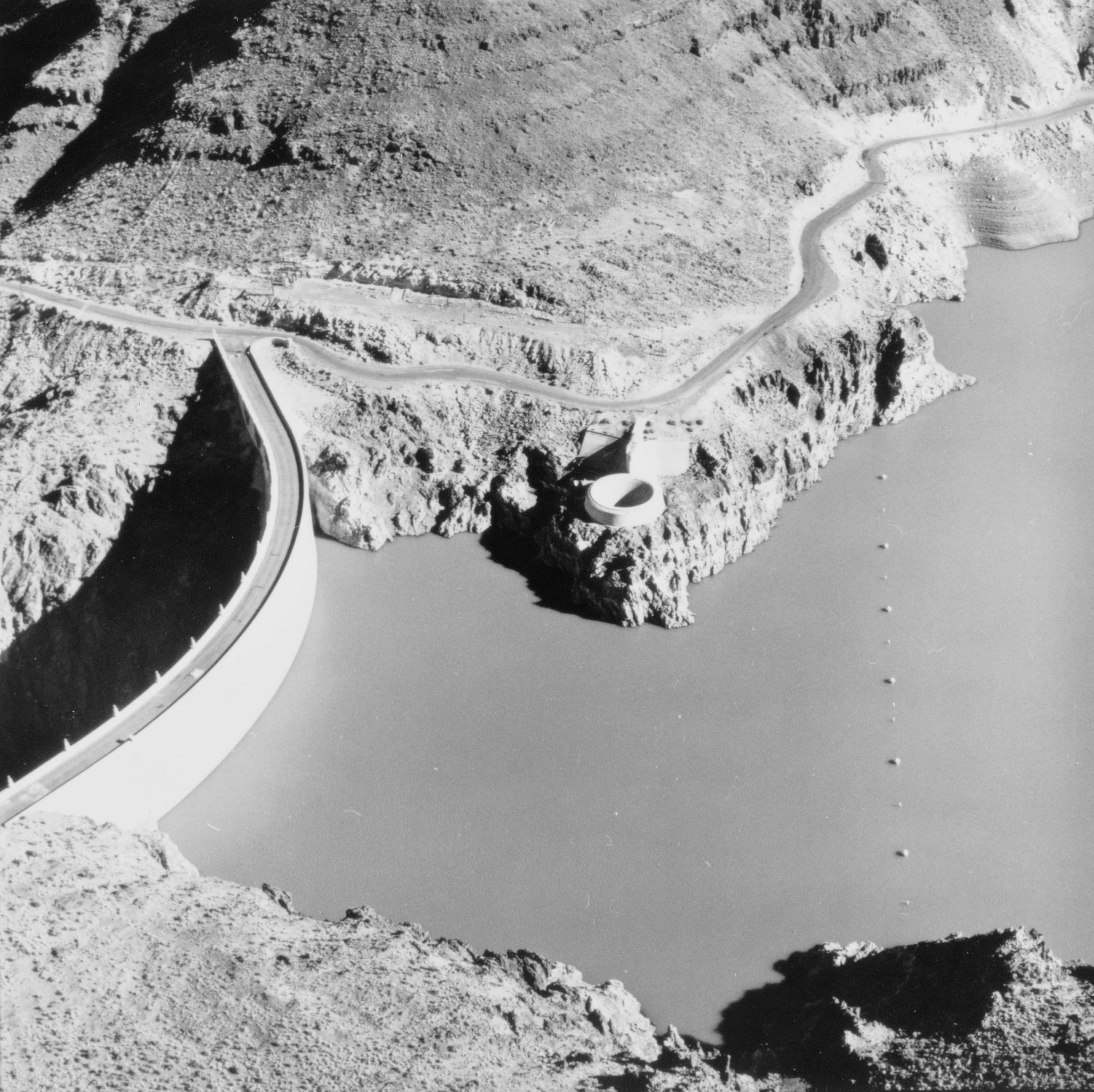 Aerial view of Owyhee Dam showing ring-gate spillway. View to northeast of Owyhee Dam, Across Owyhee River, Nyssa, Malheur County, Oregon. (source: https://www.loc.gov/pictures/resource/hhh.or0200.photos.354226p/?co=hh)