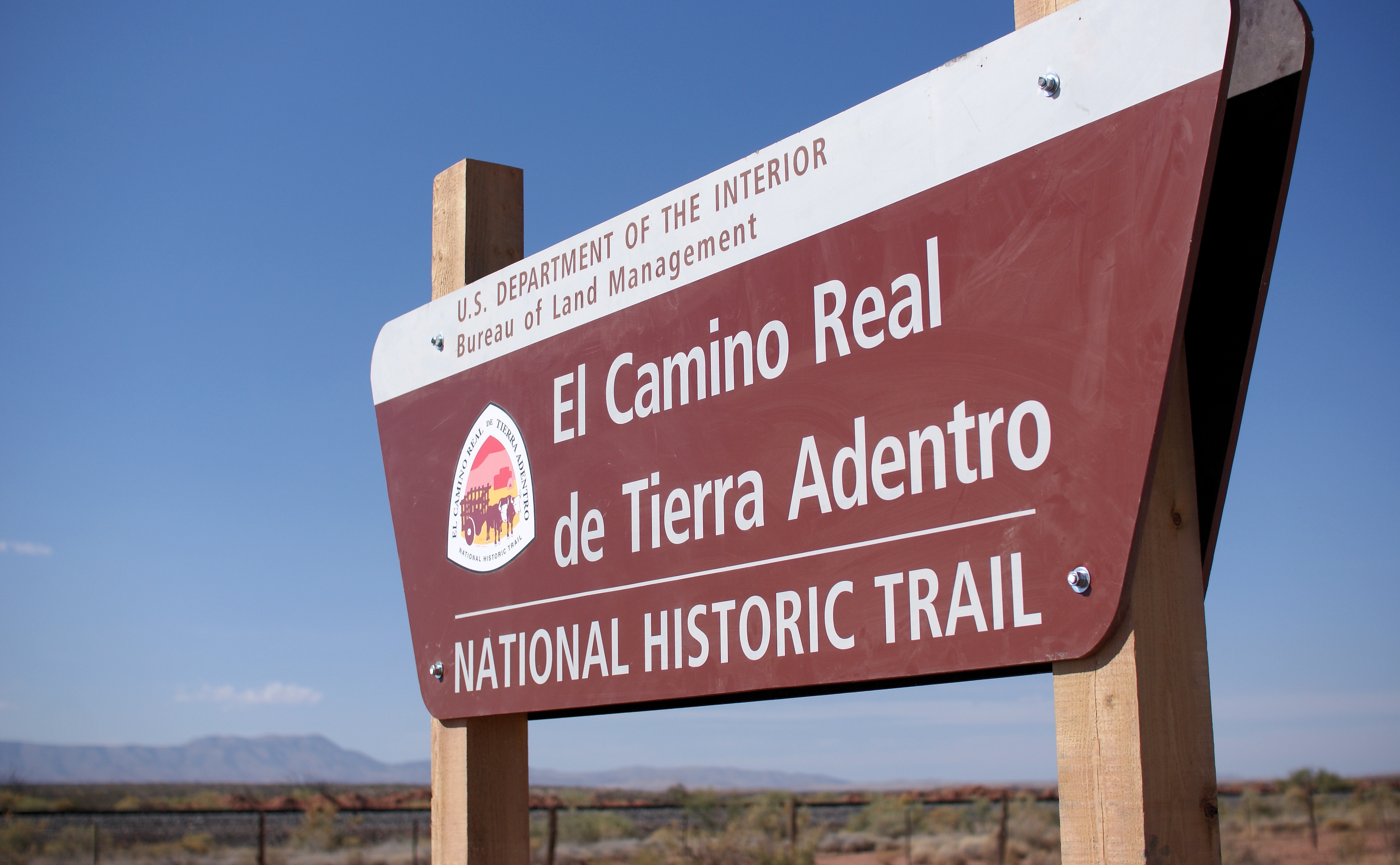 The Yost Escarpment Trailhead sign, just off of Upham Road east of Truth or Consequences, New Mexico, and a mile south of Spaceport America.

The El Camino Real de Tierra Adentro (Spanish for "The Royal Road of the Interior Land") is an ancient travel route between Santa Fe and Mexico City, whose use started in the late 16th century. The portion that travels through New Mexico passes through an arid desert known as the Jornada del Muerto (Spanish for "Journey of the Dead Man"), within which was recently created a National Historic Trail. Portions of this trail are open for hiking.