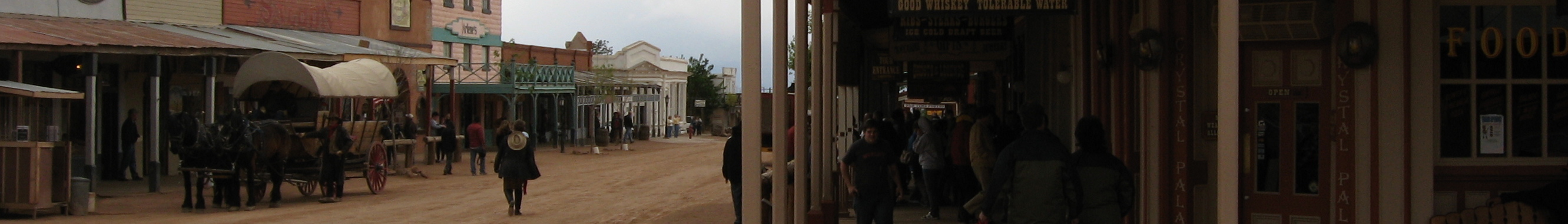 Tombstone is a city in Cochise County, Arizona, United States, founded in 1879 by Ed Schieffelin in what was then the Arizona Territory. According to 2006 Census Bureau estimates, the population of the city was 1,569.
In the summer of 1877 prospector Ed Schieffelin was working the hills east of the San Pedro River in the southeast portion of the Arizona Territory, when he came across a vein of very rich silver ore in a high plateau called Goose Flats. When Schieffelin filed his mining claim he named it "The Tombstone", after a warning given him by a passing soldier. While telling the soldier about his rock collecting experiences, the soldier told him that the only rock he was likely to collect among the waterless hills and warring Apaches of the area would be his own tombstone.
The town of Tombstone was founded in 1879, taking its name from the mining claim, and soon became a boomtown. Fueled by mineral wealth, Tombstone was a city of 1000 by the beginning of 1881, and within another year Tombstone had become the seat of a new county (Cochise County) with a population between 5,000 and 15,000, and services including refrigeration (with ice cream and later even ice skating), running water, telegraph and limited telephone service. Capitalists and businessmen moved in from the eastern U.S. Mining was carried out by immigrants from Europe, chiefly Ireland and Germany. An extensive service industry (laundry, construction, restaurants, hotels, etc.) was provided by Chinese and other immigrants.
Without railroad access the increasingly sophisticated Tombstone was relatively isolated, deep in a Federal territory that was largely unpopulated desert and wilderness. Tombstone and its surrounding countryside also became known as one of the deadliest regions in the West. Uncivilized southern gangs from the surrounding countryside, known as "cow-boys", were at odds with the northern capitalists and immigrant miners who ran the city and mines. On October 26, 1881 this situation famously exploded in the Gunfight at the O.K. Corral, leading to a continued family and political feud that resulted in multiple deaths.
On December 25, 1881 the Bird Cage Theater opened, and in 1882 the New York Times reported that "the Bird Cage Theatre is the wildest, wickedest night spot between Basin Street and the Barbary Coast."
After the mid-1880s, when the silver mines had been tapped out, the main pump failed, causing many mines to be flooded with deep groundwater, and Tombstone declined rapidly. The U.S. census found it had fewer than 1900 residents in 1890, and fewer than 700 residents in 1900.
The 1900 census was a minimum, however, and Tombstone was saved from becoming a ghost town after the decline of silver mining, partly by its status as the Cochise County seat. Even the county seat was later moved by popular vote to nearby Bisbee in 1929. However, the classic Cochise County Courthouse and adjacent gallows yard in Tombstone is preserved as a museum.
Tombstone is home to perhaps the most famous graveyard of the Old West, Boot Hill. Buried at the site are various victims of violence and disease in Tombstone's early years, including those from the O.K. Corral. Boot Hill (also known as the old city cemetery) was also the destination for bad-men and those lynched or legally hanged in Tombstone. Admission to this historic site is free and donations are accepted.
The lot in which the historic gunfight at the O.K. Corral occurred in 1881 is also preserved, but this has been walled off, and admission is charged. However, since much of this streetfight occurred in Tombstone's Fremont Street (modern Highway 80), much of this site is also viewable without admission charge.
<a href="http://en.wikipedia.org/wiki/Tombstone,_Arizona" rel="noreferrer nofollow">en.wikipedia.org/wiki/Tombstone,_Arizona</a>
<a href="http://en.wikipedia.org/wiki/Wikipedia:Text_of_Creative_Commons_Attribution-ShareAlike_3.0_Unported_License" rel="noreferrer nofollow">en.wikipedia.org/wiki/Wikipedia:Text_of_Creative_Commons_...</a>