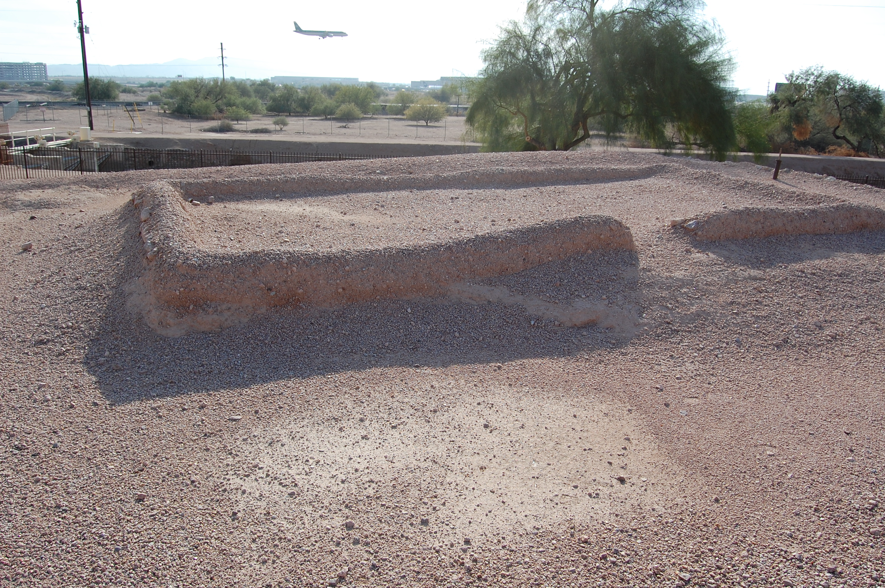 Ruins of a building at Pueblo Grande archaeological site in Phoenix, Arizona.  Note the plane landing at Sky Harbor International Airport just behind the dig site.