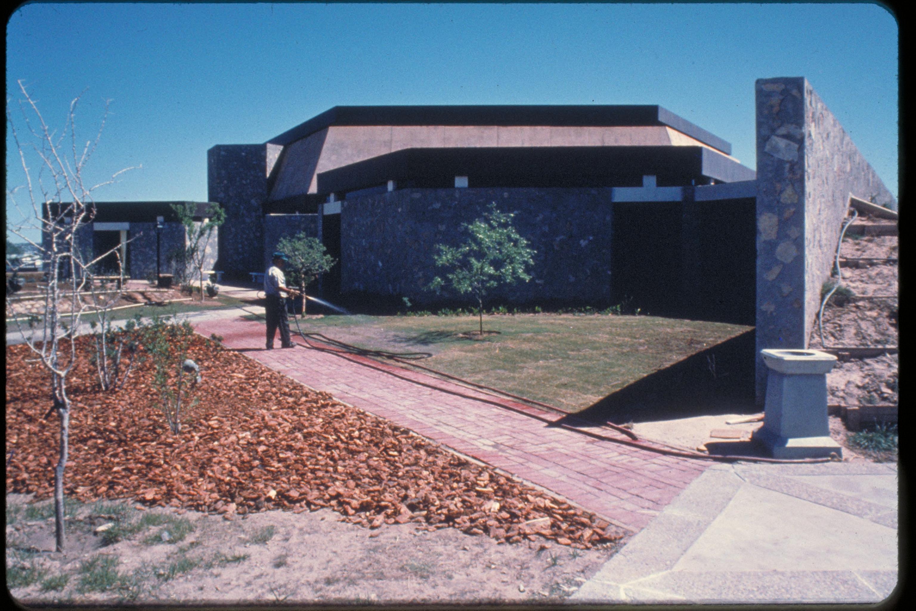 Staff member waters trees outside the center.
The Chamizal Convention was a milestone in diplomatic relations between Mexico and the United States in 1963. Chamizal National Memorial was established to commemorate this treaty which resulted in the peaceful settlement of a century-long boundary dispute between the neighboring countries. Far more than mere acreage, Chamizal is an idea, a dynamic process, dedicated to furthering the spirit of understanding and goodwill between two nations that share one border.
Keywords: cham; National monuments; International cooperation; International boundary; United States - Mexico relations