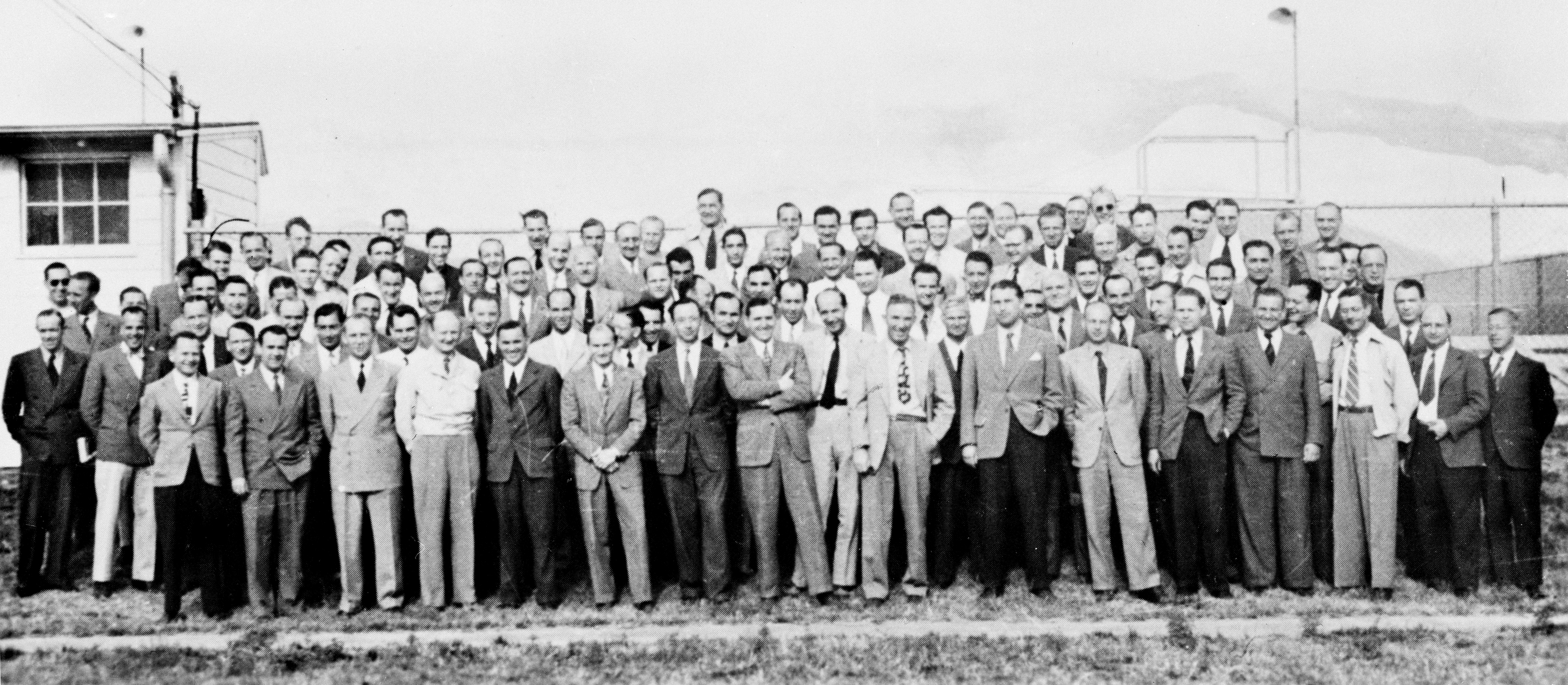 Group of 104 German rocket scientists in 1946, including Wernher von Braun,[1] Ludwig Roth and Arthur Rudolph, at Fort Bliss, Texas.  The group had been subdivided into two sections:  a smaller one at White Sands Proving Grounds for test launches and the larger at Fort Bliss for research.[2]   Many had worked to develop the V-2 Rocket at Peenemünde Germany and came to the U.S. after World War II, subsequently working on various rockets including the Explorer 1 Space rocket and the Saturn (rocket) at NASA.

Titles and Captions in Published Books
Von Braun Rocket Team at Fort Bliss, Texas[3]
Members of the German rocket team who worked on rockets for Army Ordnance under Paperclip are shown at White Sands Proving Ground, New Mexico, in 1946[4]
Peenemünde's core personnel is reassembled at White Sands, New Mexico, in 1946.[5]
Von Braun group at White Sands Proving Ground, 1946[6]
