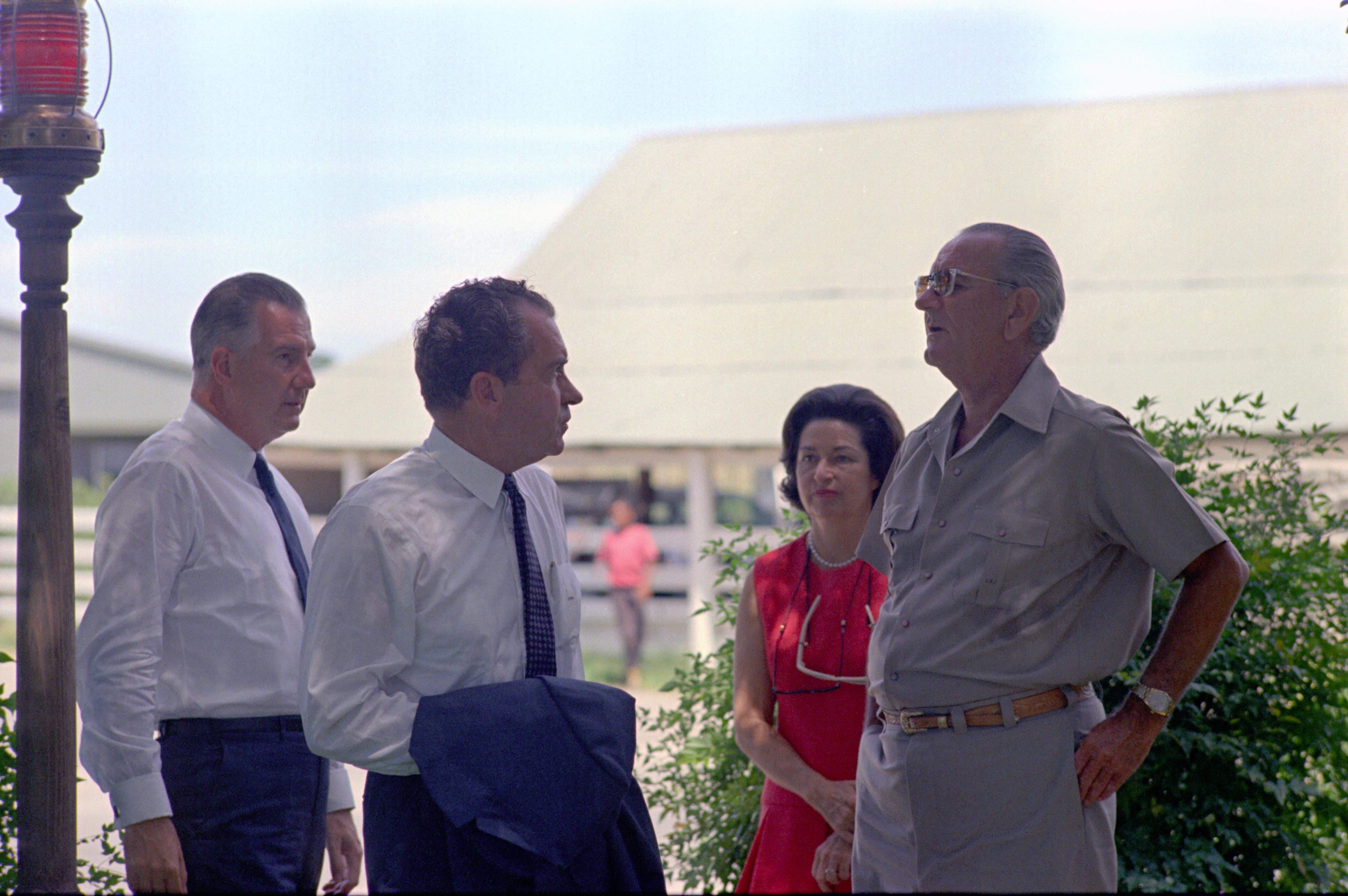 President Lyndon B. Johnson meets with Republican nominees Richard Nixon and Spiro Agnew as First Lady Lady Bird Johnson looks on at President Johnson's ranch in Stonewall, Texas in August 1968.