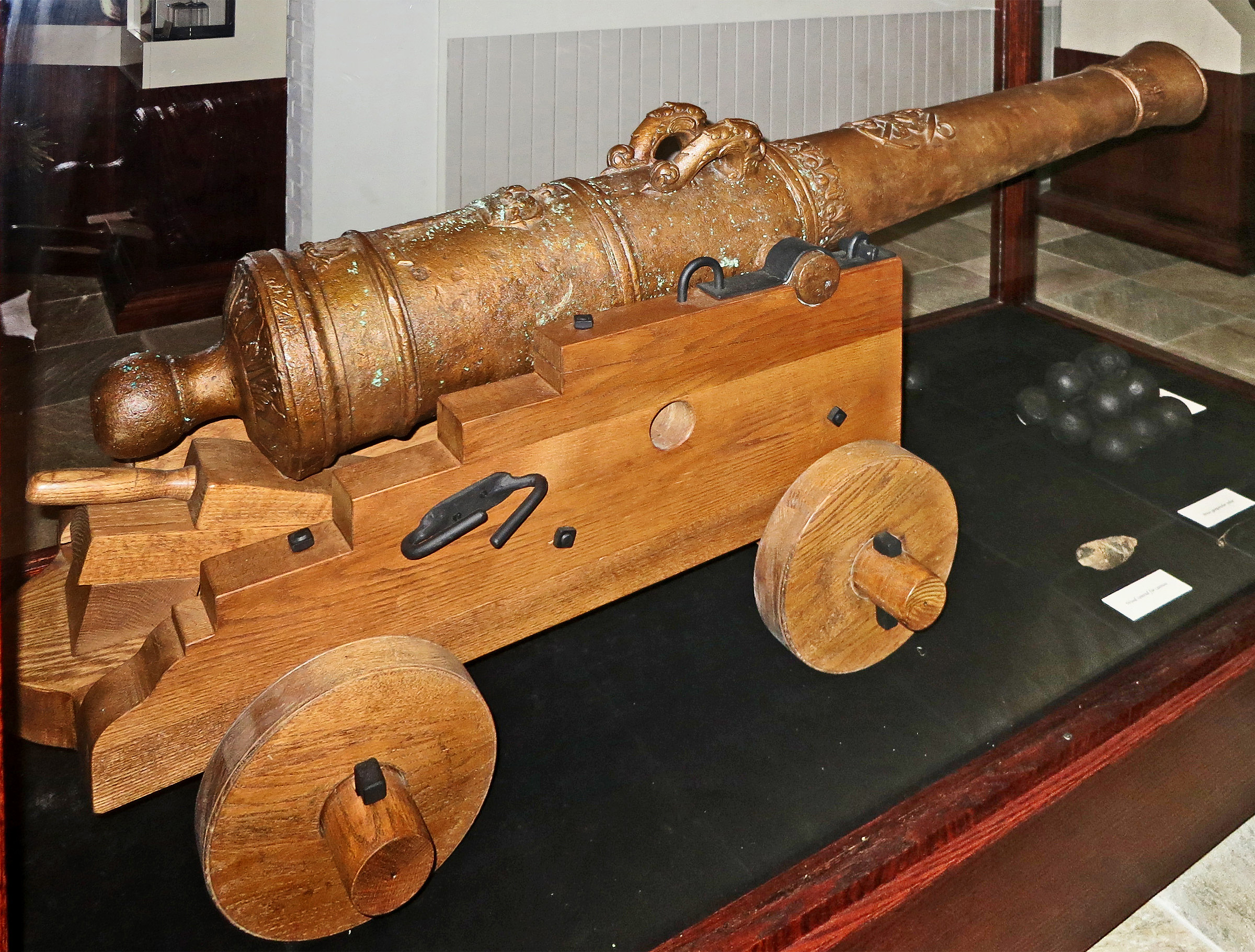 This Bronze four-pound cannon is from Robert de La Salle's ship La Belle. It sank during a storm in 1685, and the wreckage stayed on the seabottom for over three centuries. This is one of 3 such cannons recovered and is in the Matagorda County Museum in Bay City, Texas. (The wooden wheeled stand is a modern recreation.)