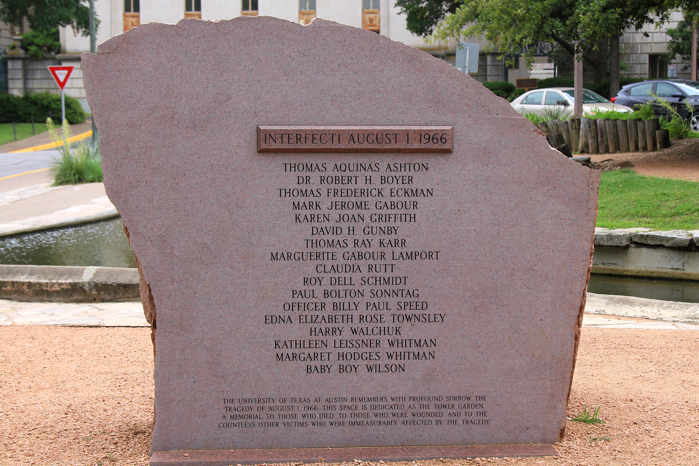 Pink granite memorial to those killed at the University of Texas tower shooting in Austin, Texas, United States on August 1, 1966. The Tower Memorial Enhancement Group placed the memorial with approval from the University of Texas Division of Diversity and Community Engagement. Cook-Walden Funeral Homes and Cemeteries paid for the memorial and bench to honor Charles Walden, the former owner of Cook-Walden, who was present during the shooting and used his company's hearses as ambulances.