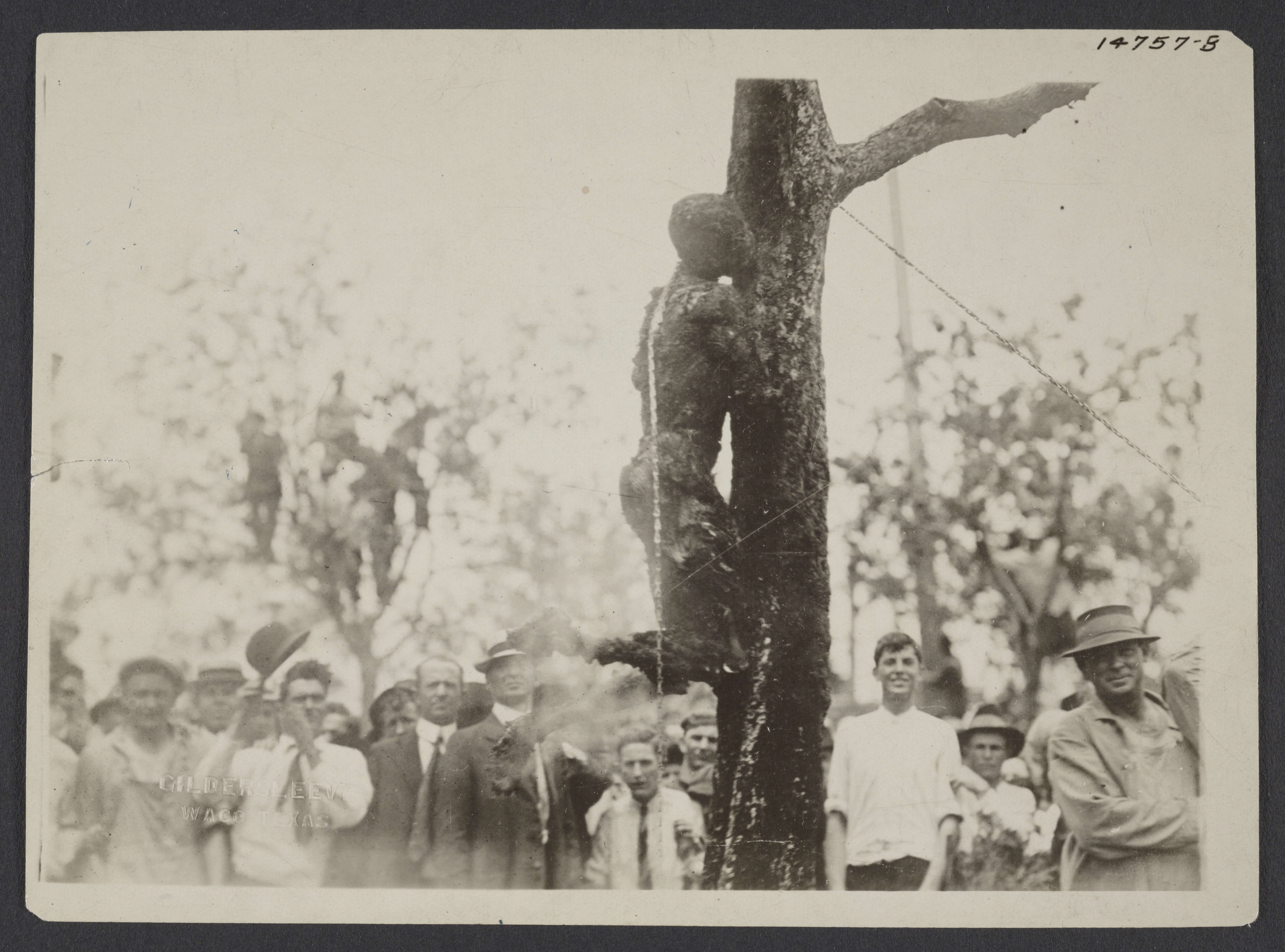 Large crowd looking at the burned body of Jesse Washington, 18 year-old African American, lynched in Waco, Texas, May 15, 1916