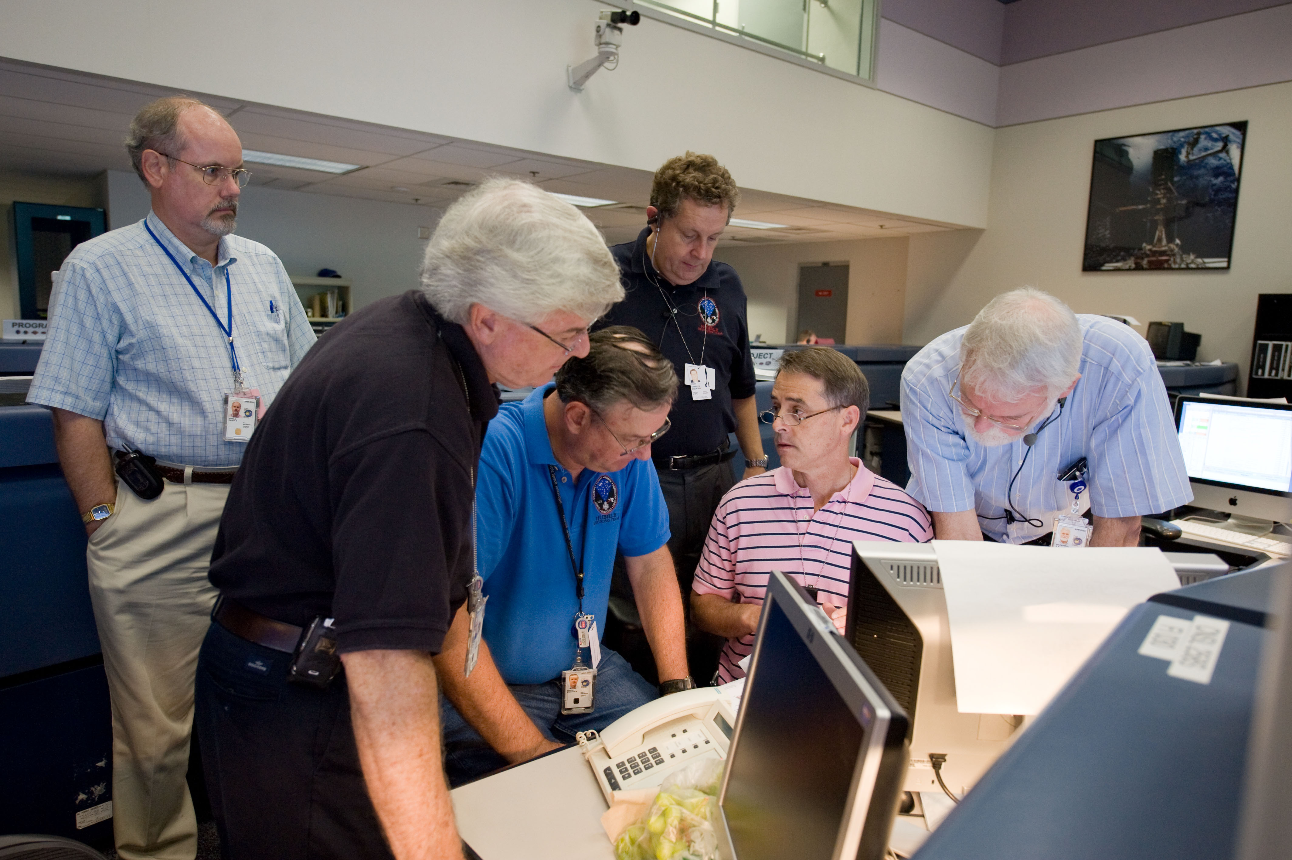 HST senior managers discuss mission progress and plans in the Blue Flight Control Room at Johnson Space Center during Servicing Mission 4. Shown here (from left) are HST project scientist Randy Kimble, senior HST project scientist Dave Leckrone, HST program manager Preston Burch, STScI director Matt Mountain, HST deputy project manager Mike Kienlen, and deputy manager for HST Operations Project Keith Kalinowski.
Credit: NASA