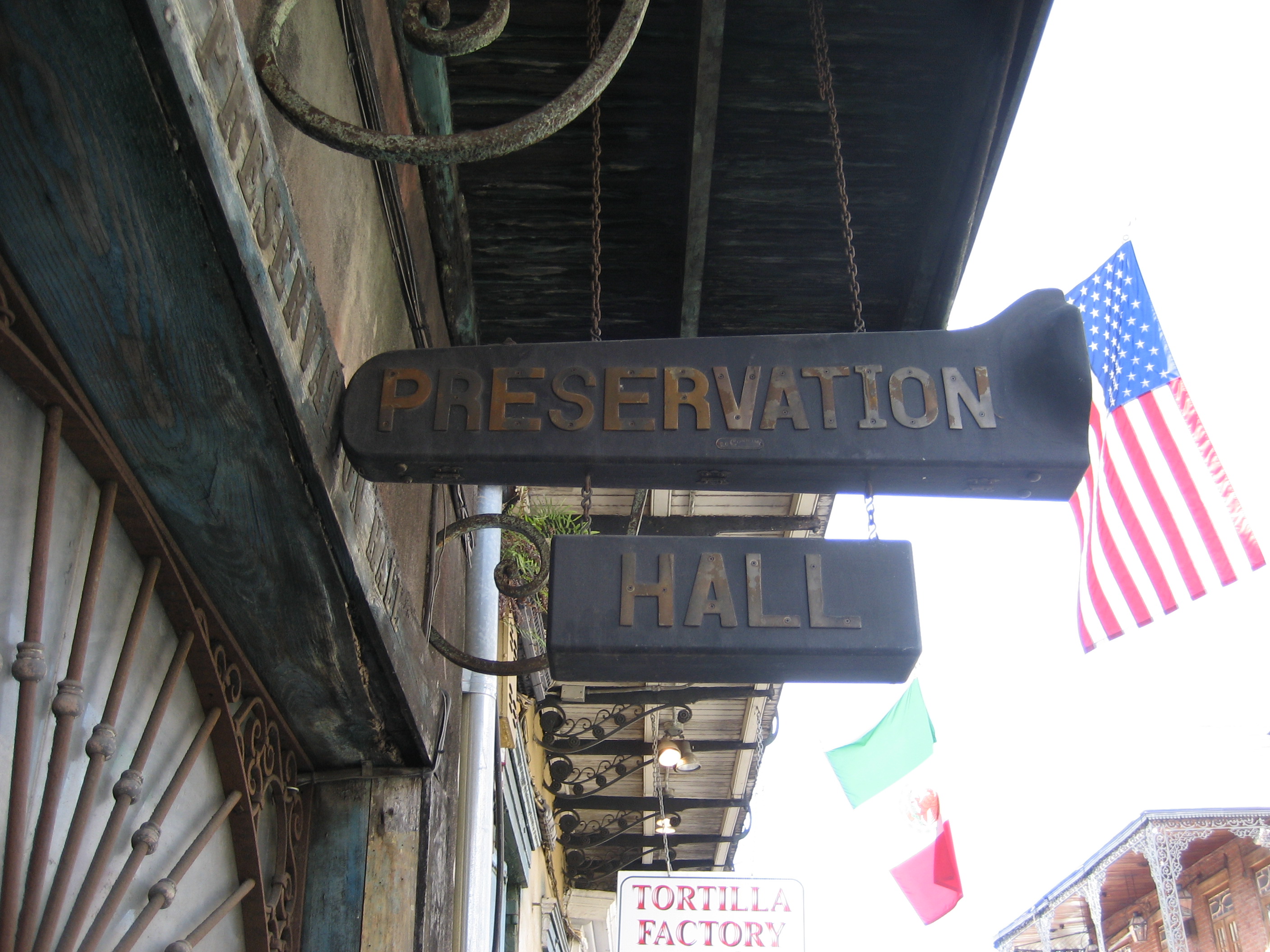 Sign over the entrance of Preservation Hall in the French Quarter, New Orleans, Louisiana. Sign is made from old trumpet and trombone cases.